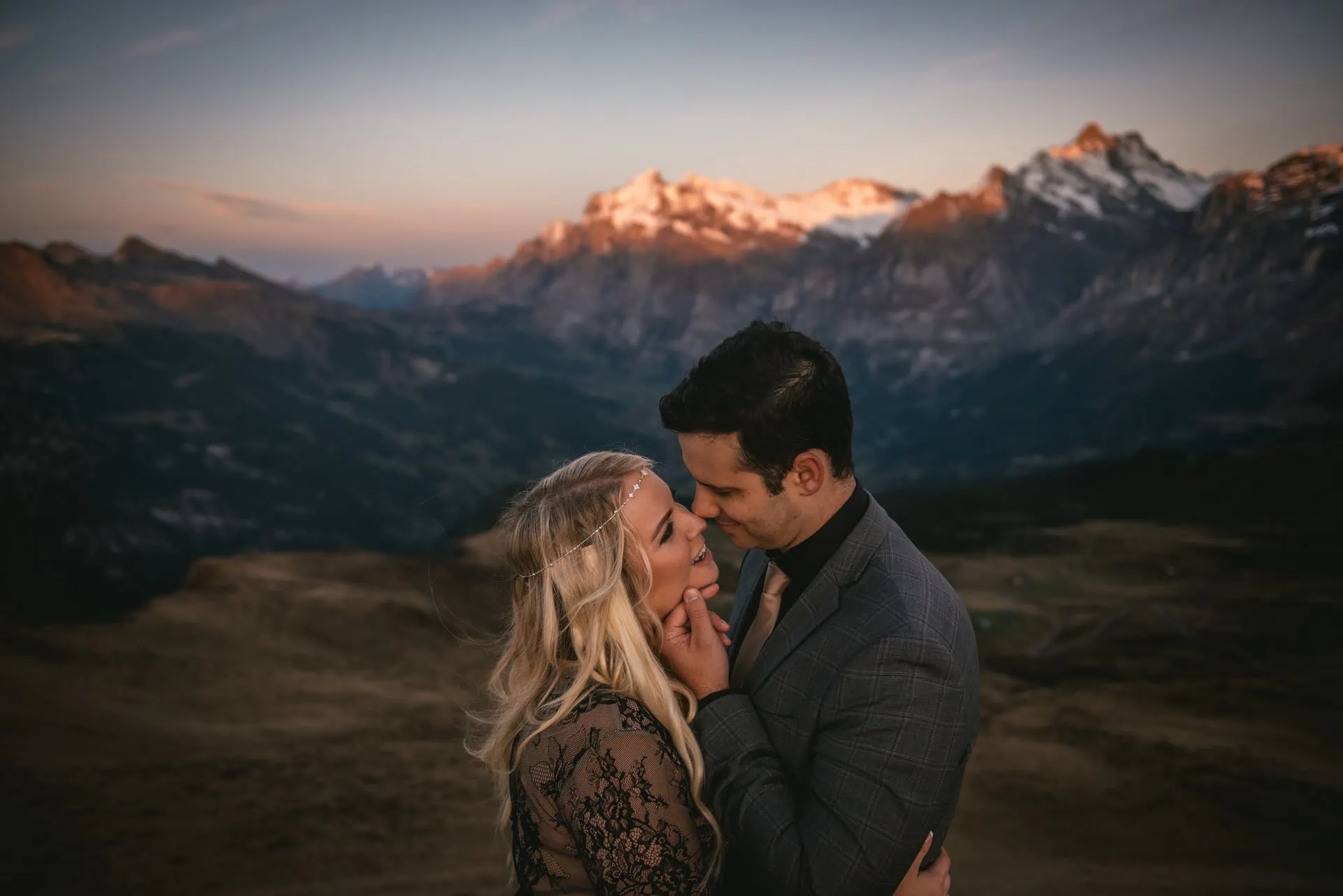 Couple enjoying the alpenglow in the Lauterbrunnen valley at sunset on their elopement day in Switzerland