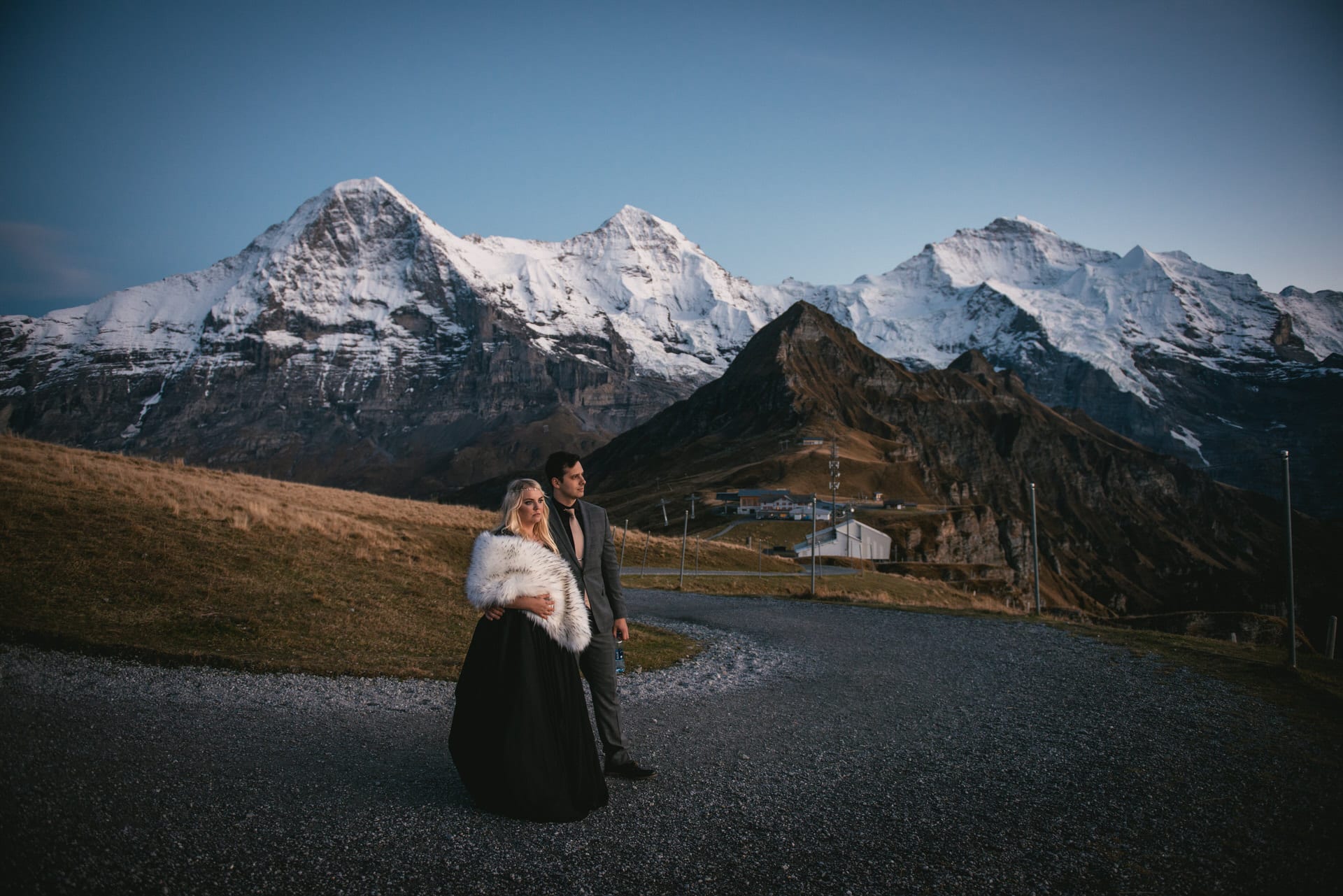Couple enjoying the blue hour on top of the Mannlichen on their elopement day in Switzerland