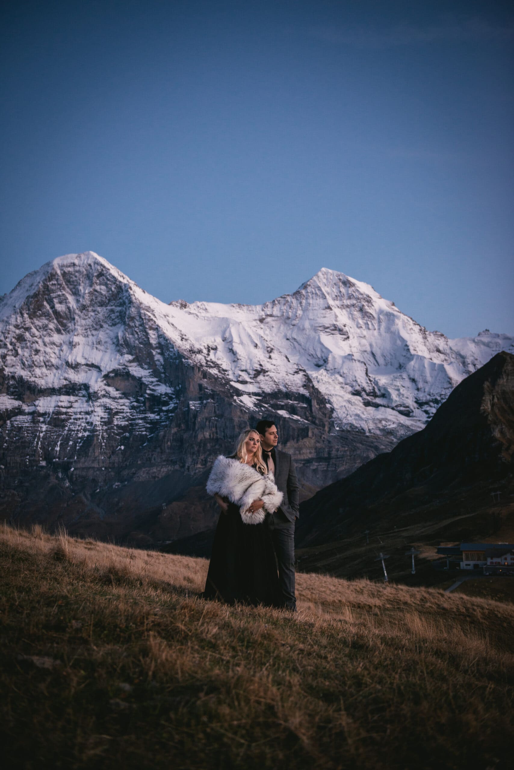 Couple enjoying the blue hour on top of the Mannlichen on their elopement day in Switzerland