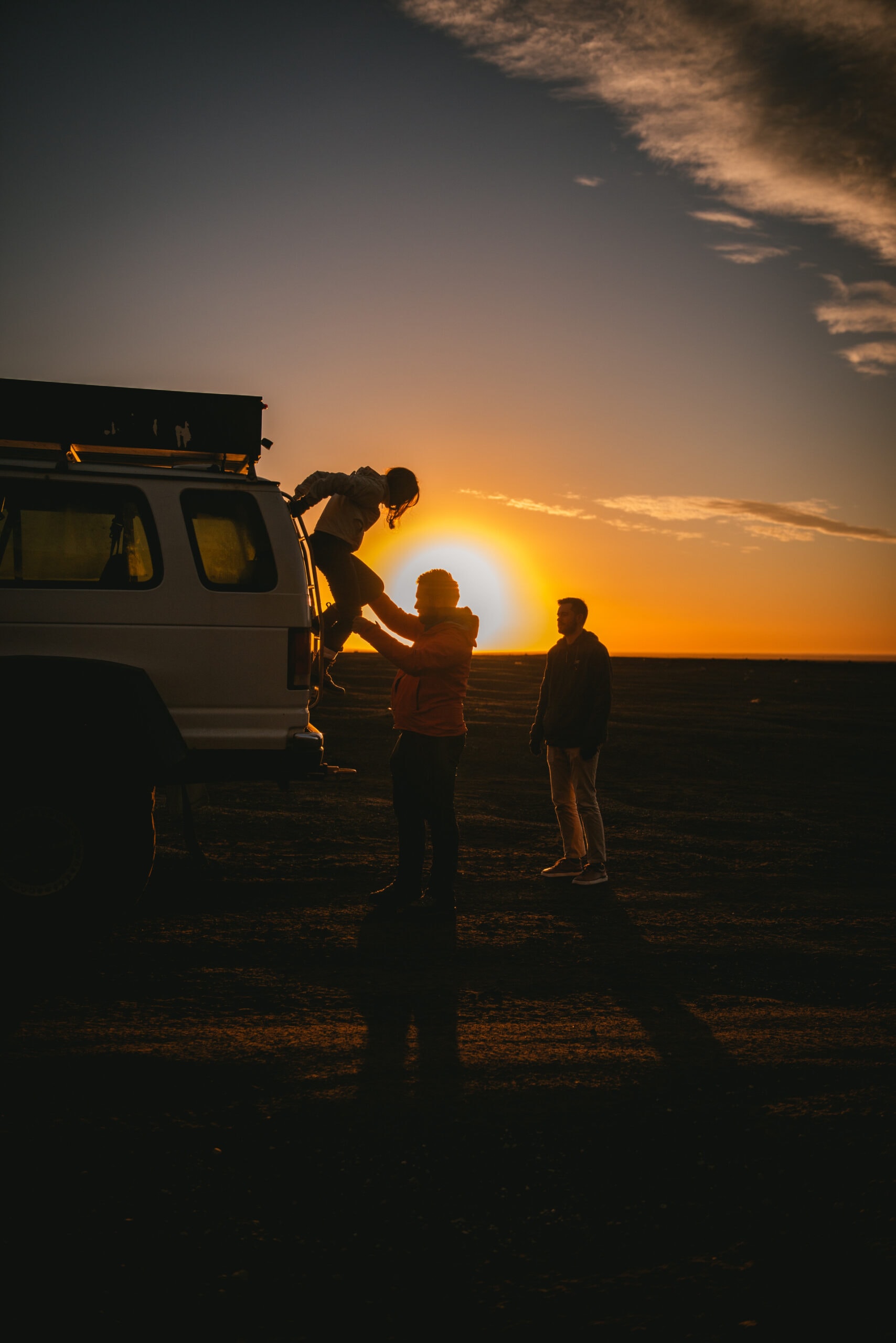 Couple getting down the superjeep at sunrise after their elopement in Iceland