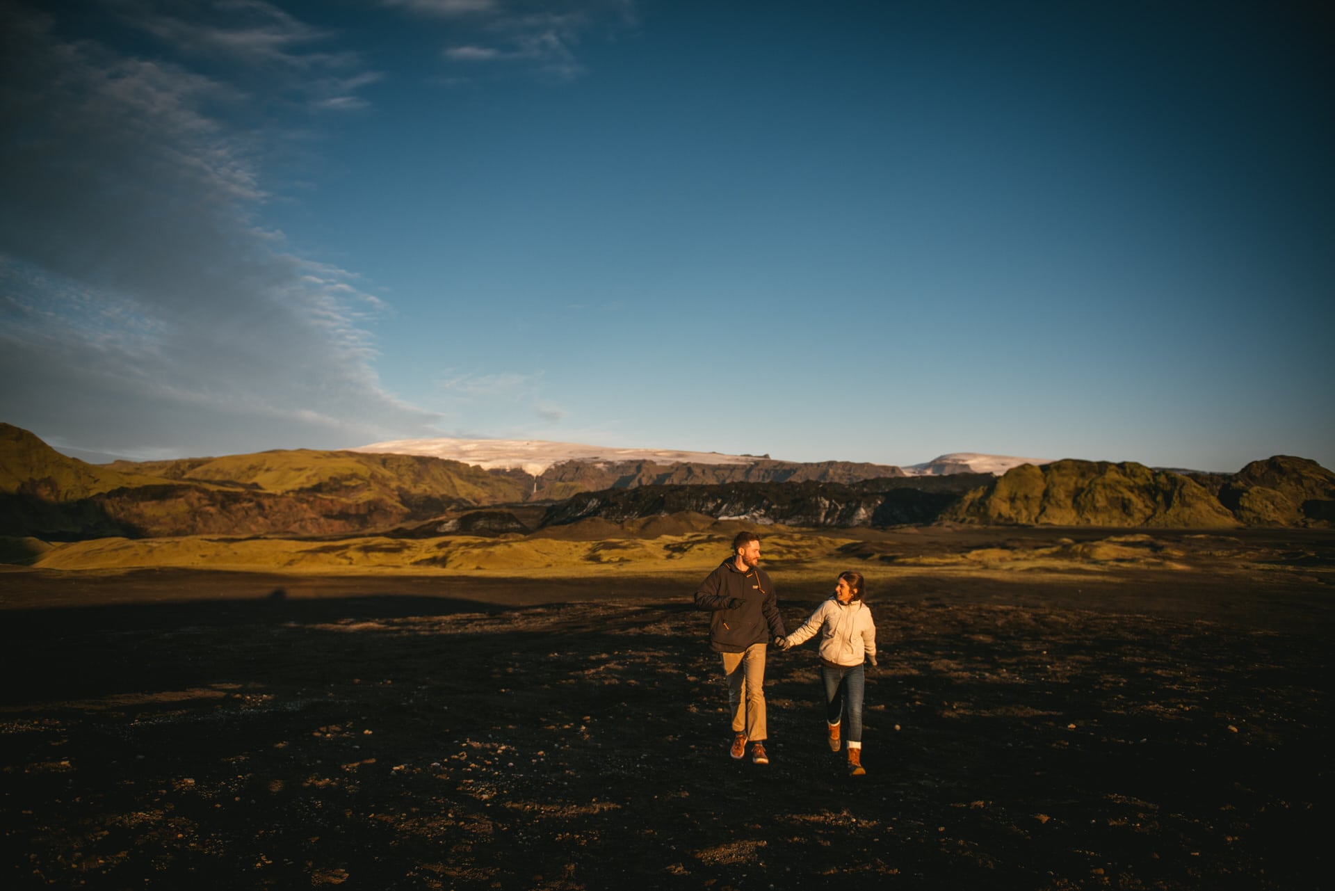 Couple running in the Katla delta after their elopement in Iceland