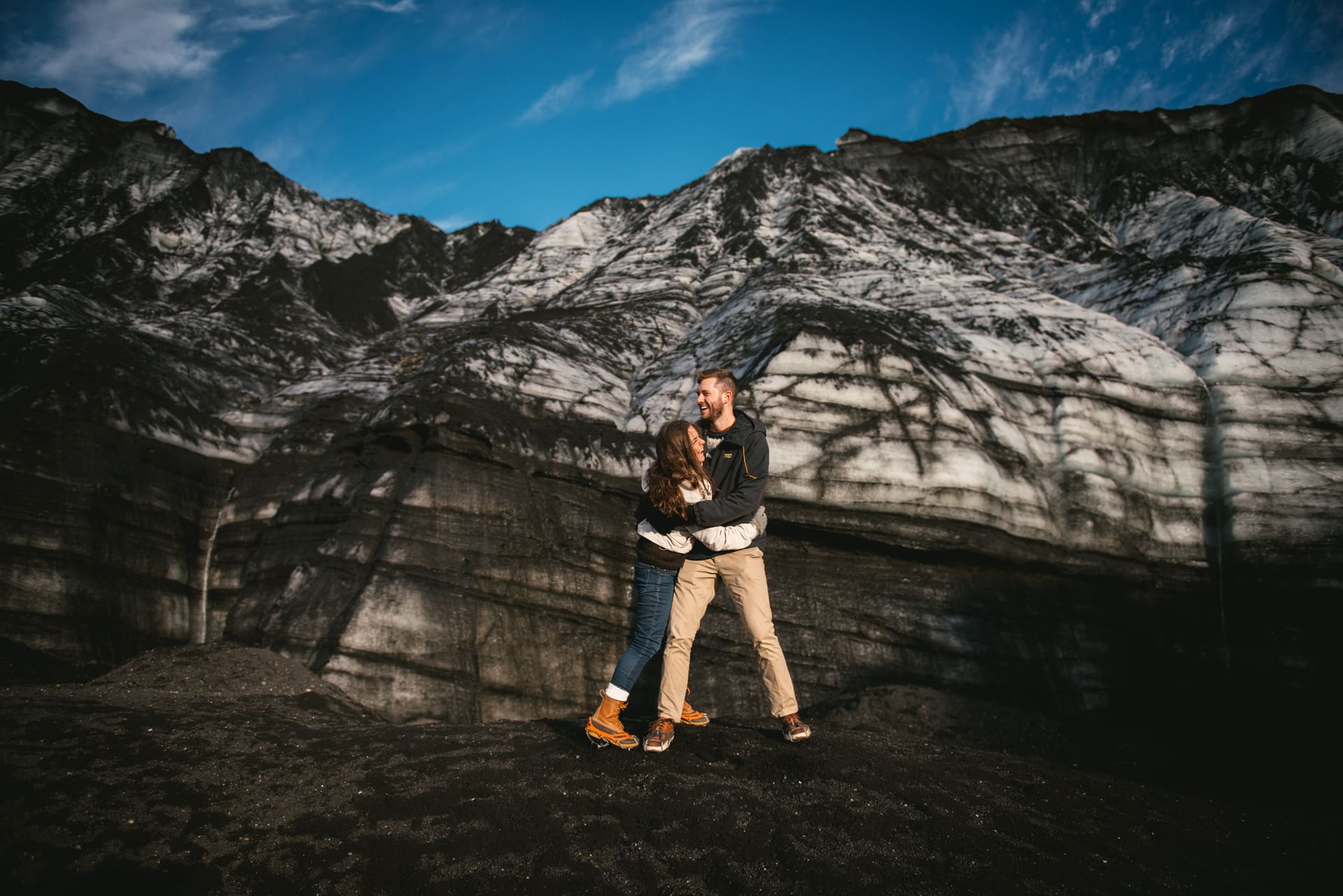 Couple hugging in front of a glacier after their elopement in Iceland