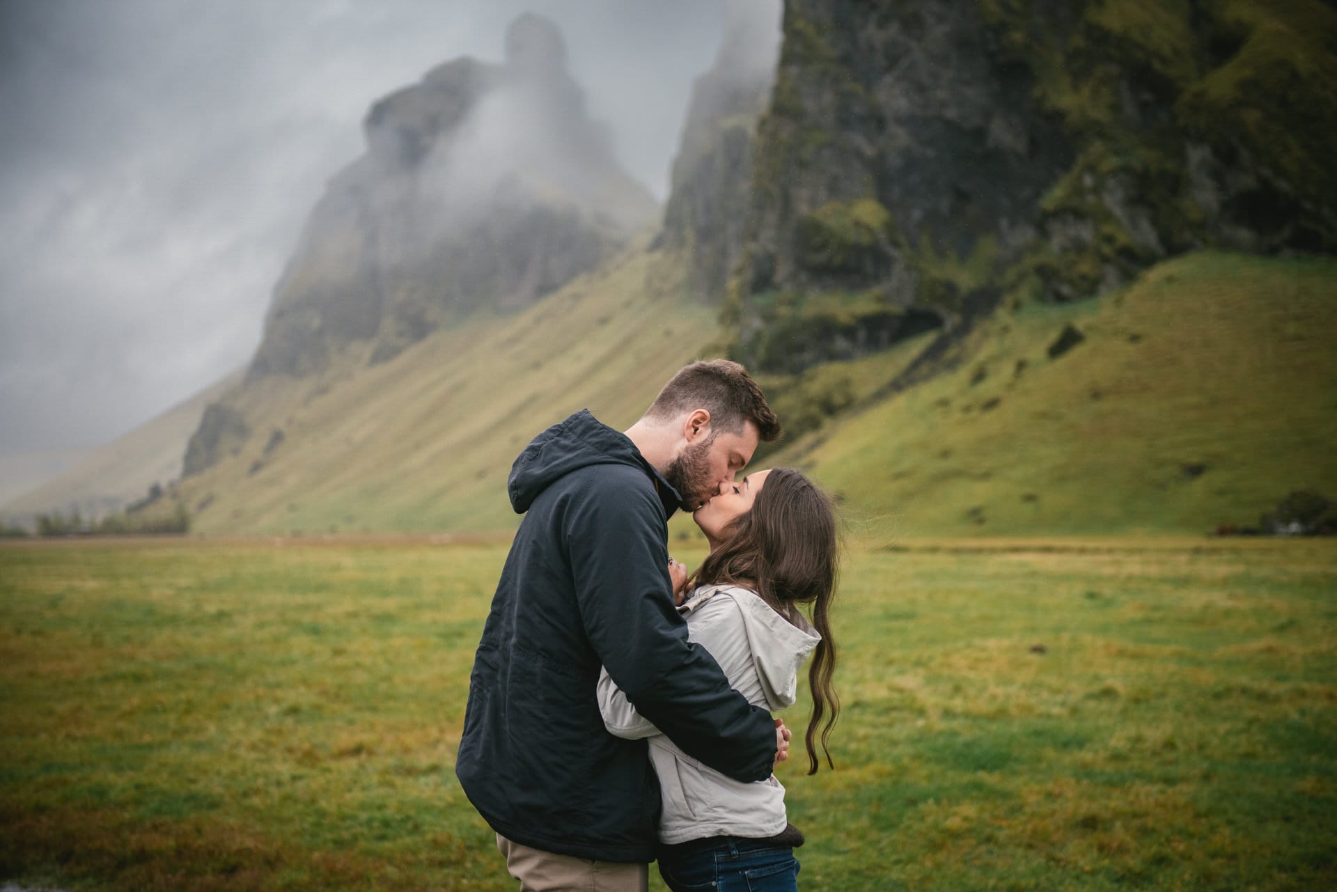 Couple kissing in front of mountains before their elopement in Iceland