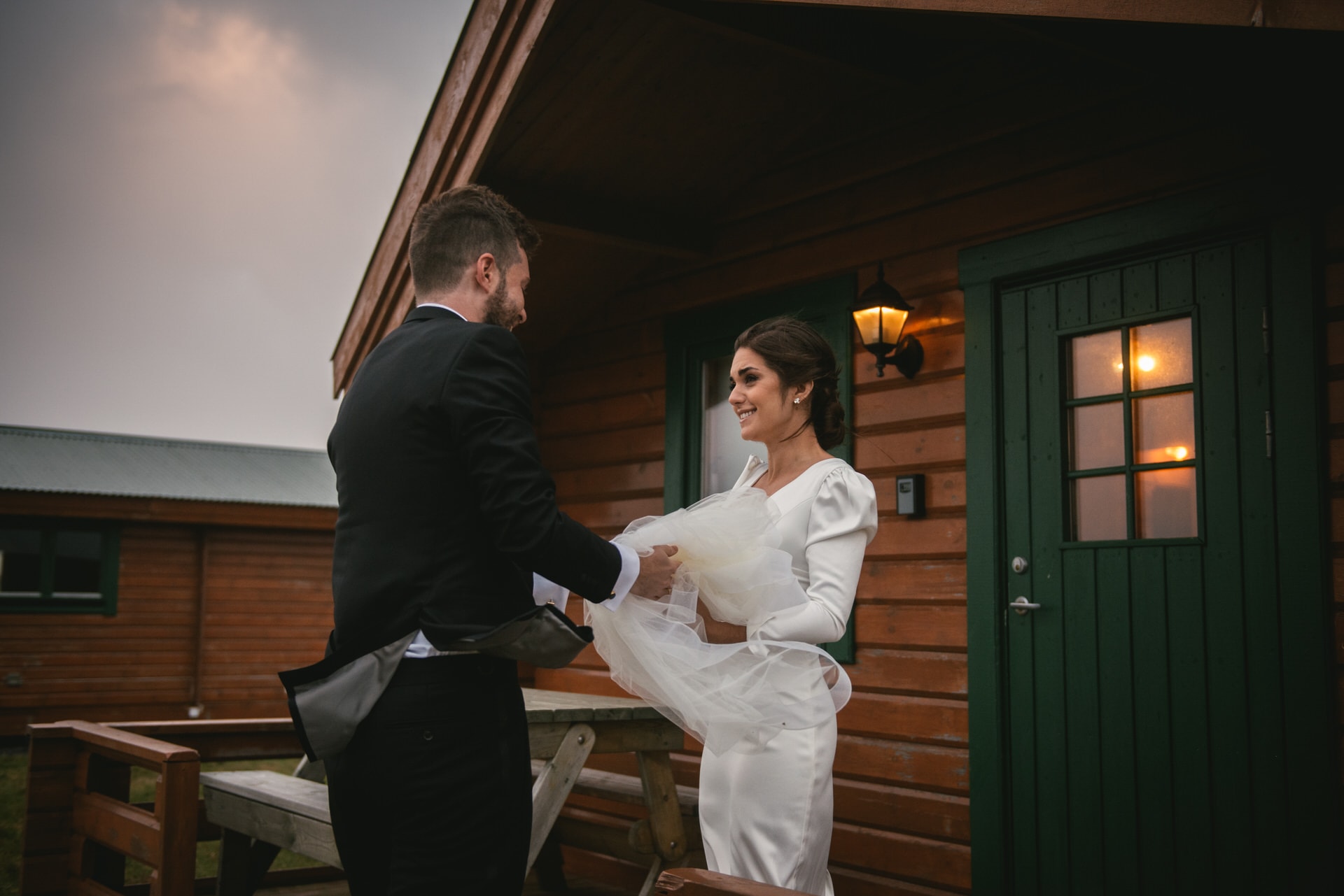 Groom getting back the bride's veil after it blew off with the wind in Iceland