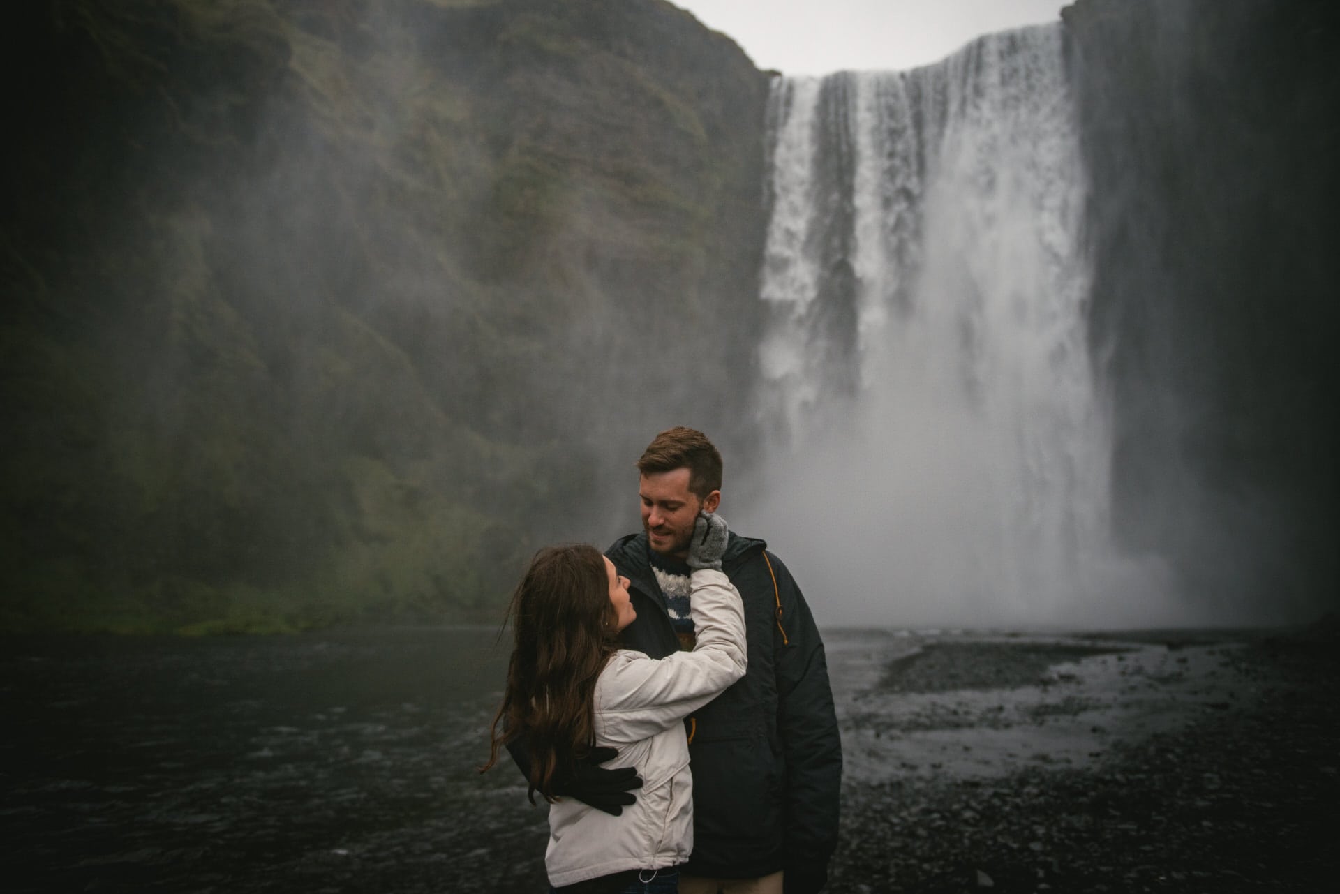 Couple posing in front of Skogafoss before their elopement in Iceland