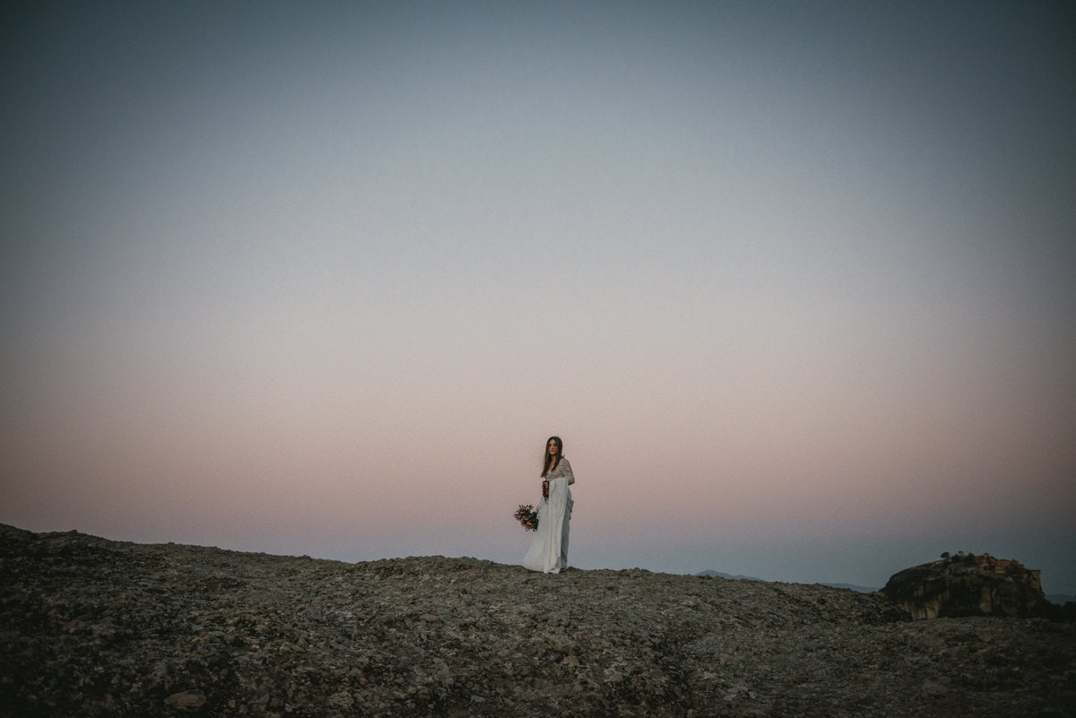 Bride on rocks on her day after photoshoot in the Meteora in Greece