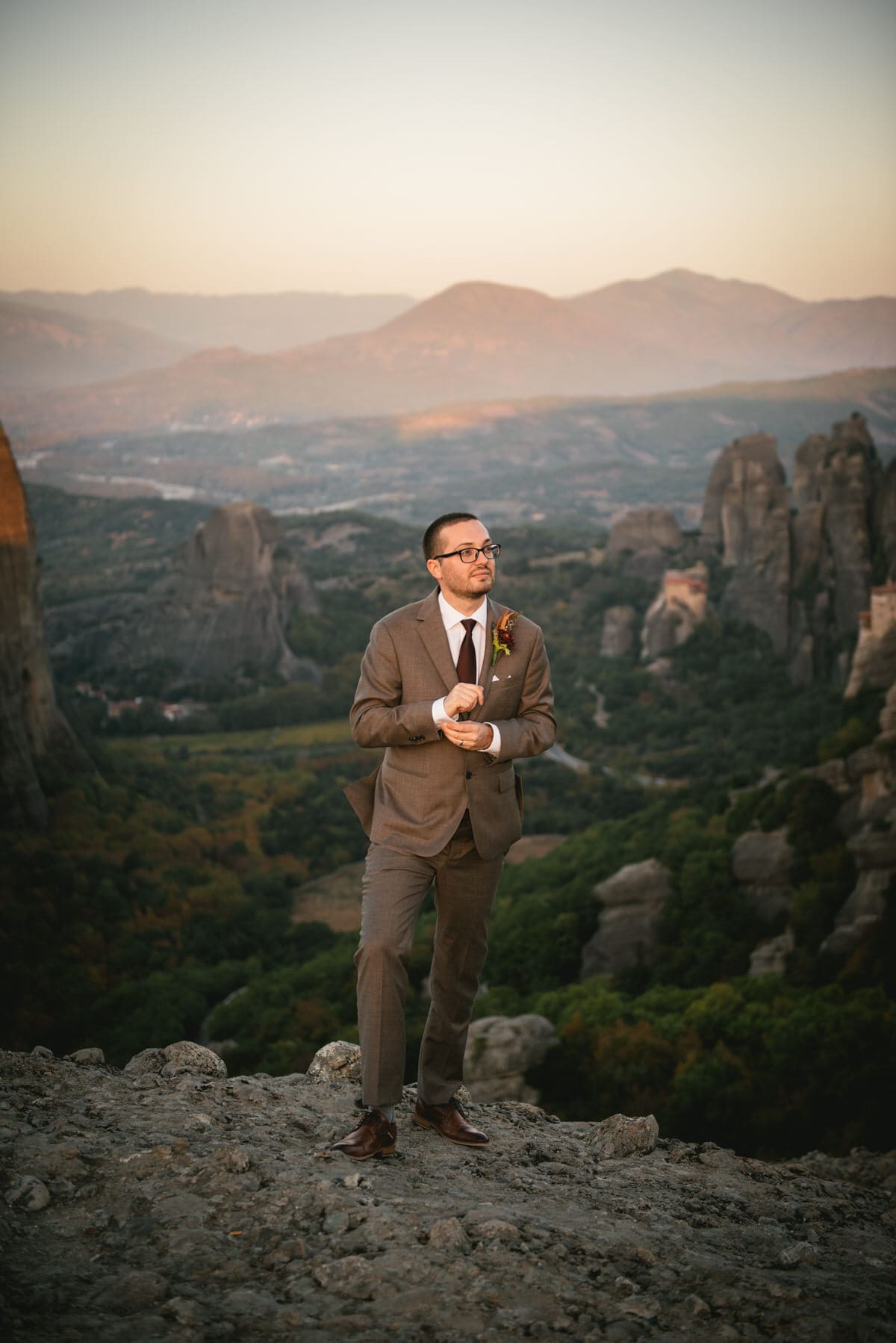 Groom posing on their day after photoshoot in the Meteora in Greece