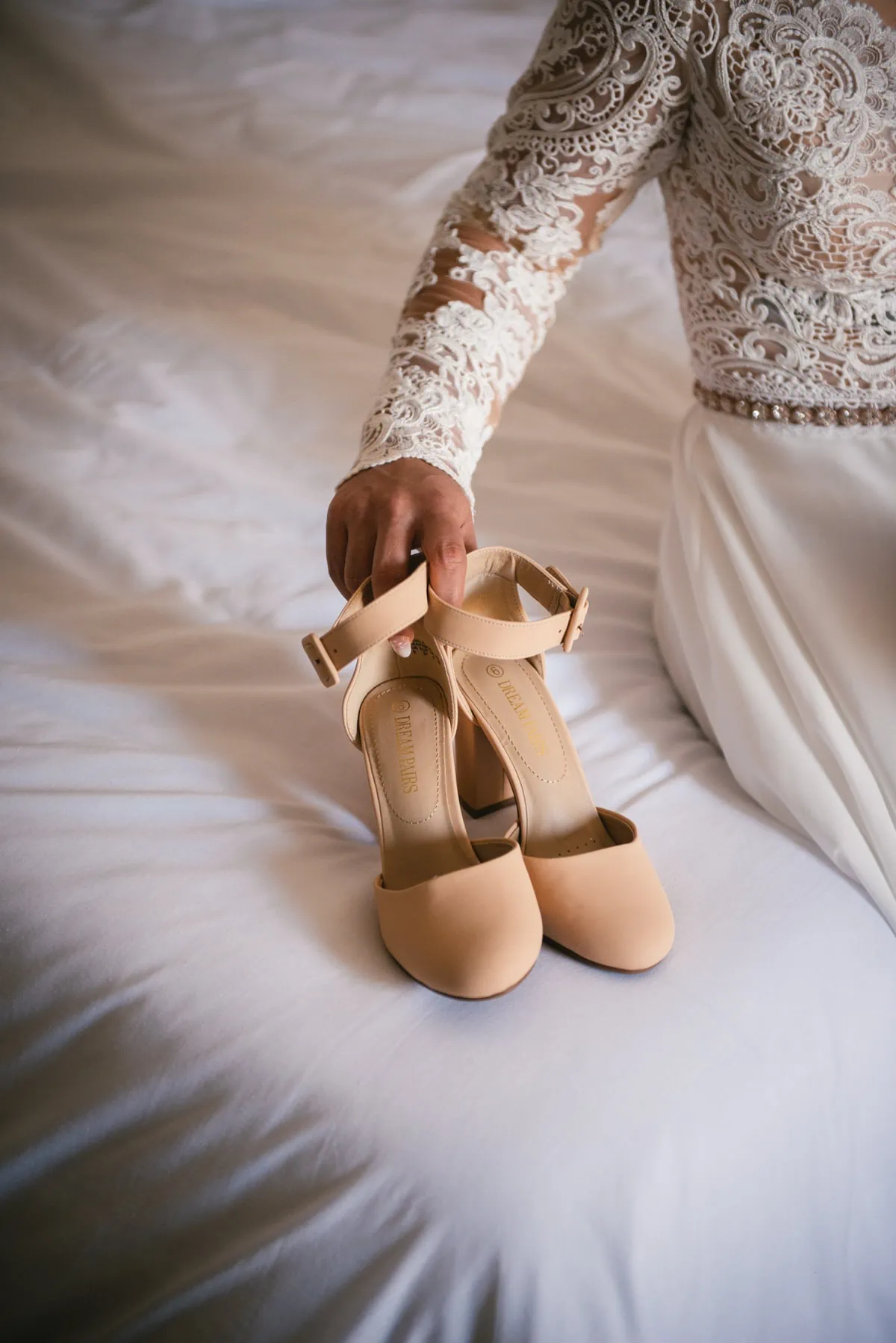 Bride picking up her shoes on an elopement day in the Meteora