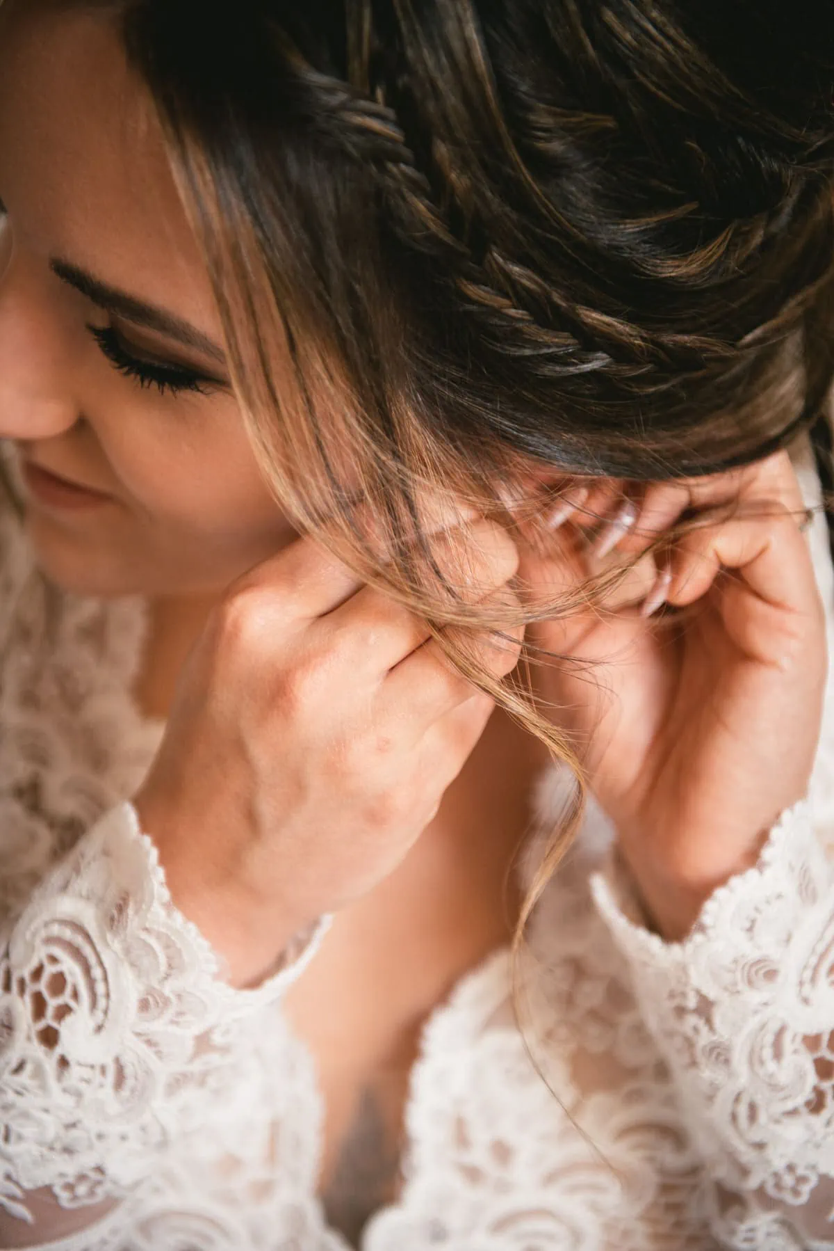 Bride putting her earrings on on an elopement day in the Meteora