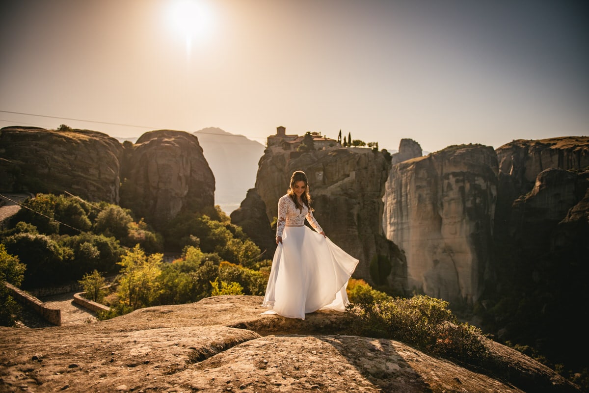 Bride playing with her dress on an elopement day in the Meteora