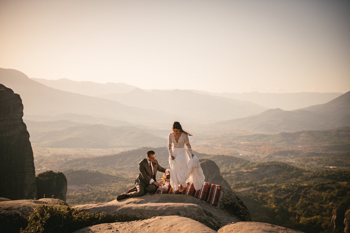 Bride and groom finishing their picnic on an elopement day in the Meteora