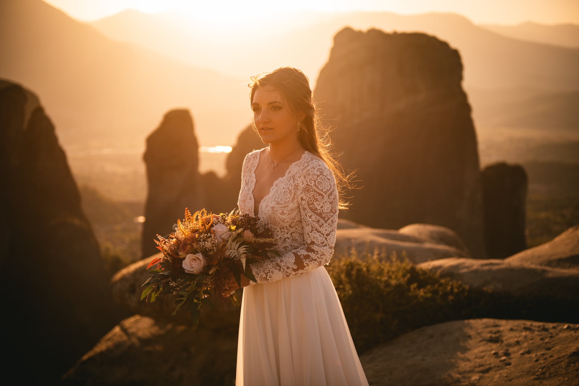 Bride standing on a rock on her Meteora wedding elopement ceremony