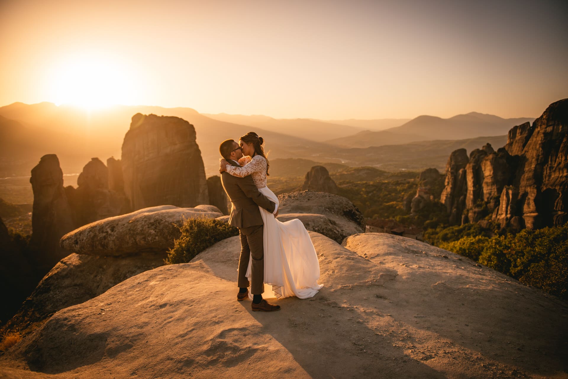Couple posing at sunset on their Meteora wedding elopement