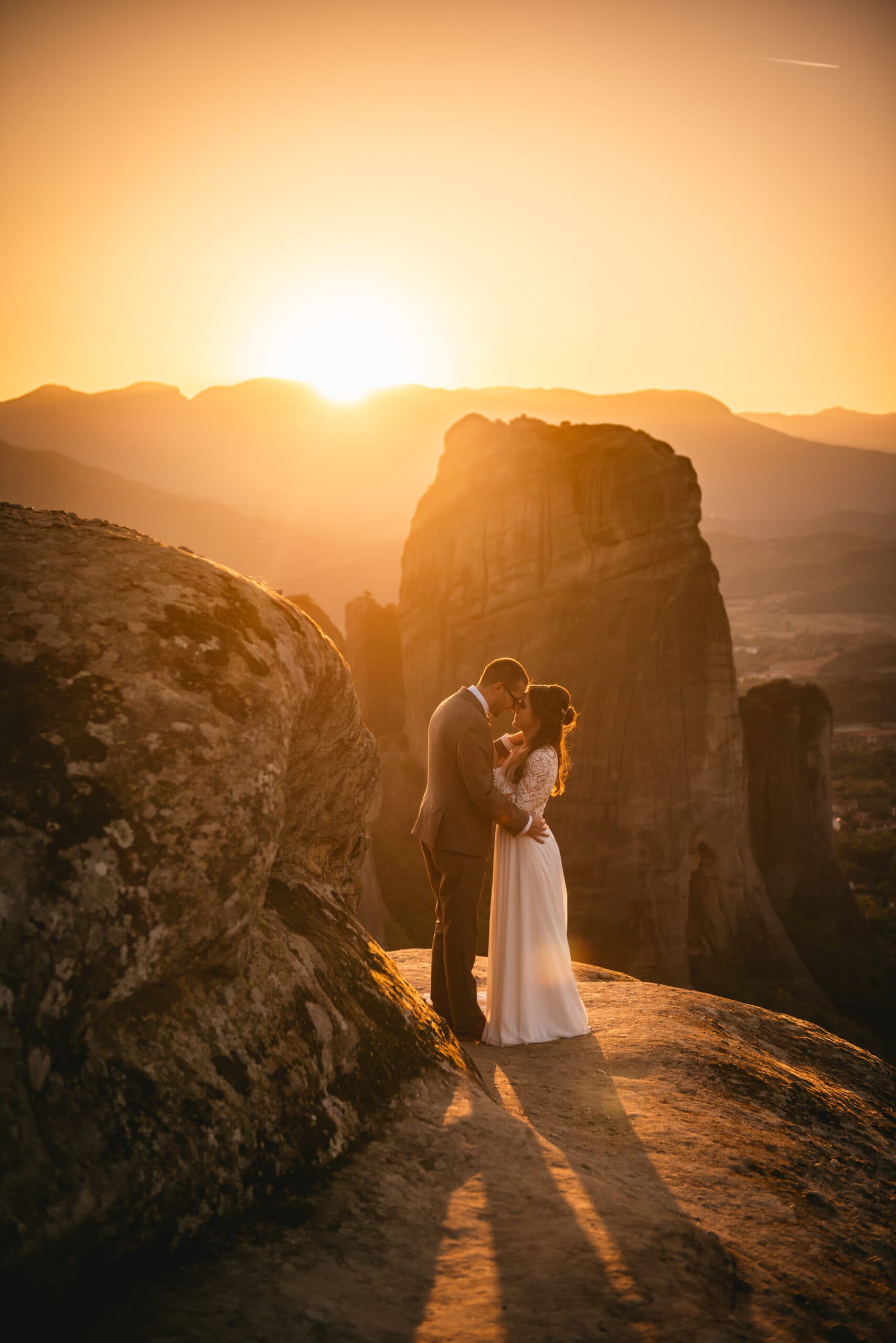 Couple with an epic sunset on their Meteora wedding elopement