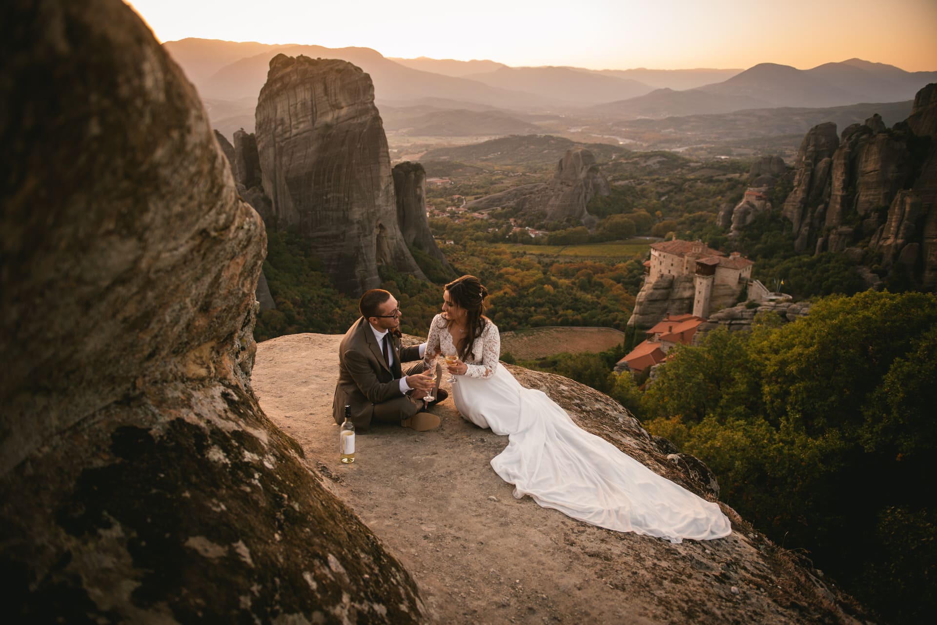 Couple drinking champagne on their Meteora wedding elopement