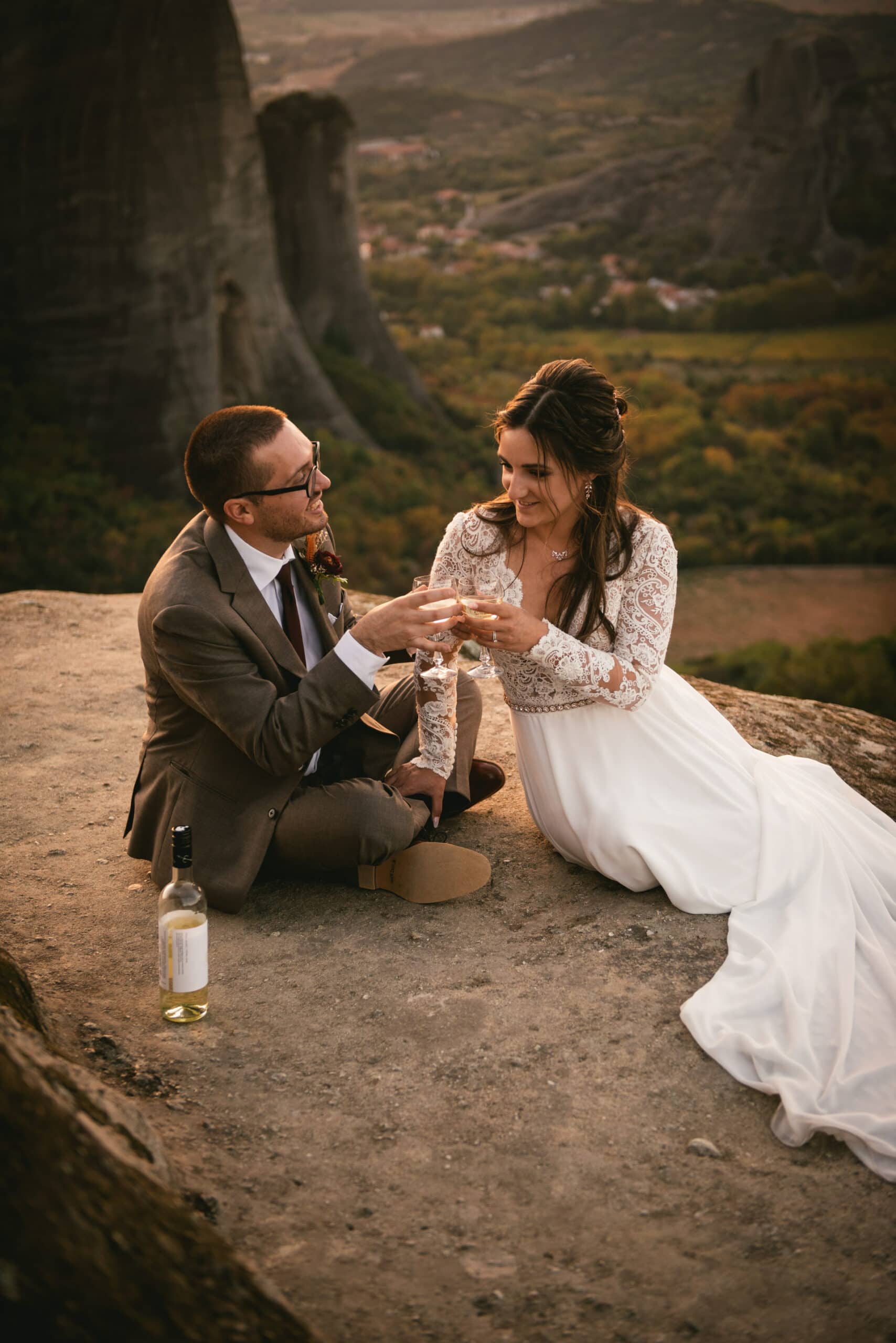 Couple toasting with champagne on their Meteora wedding elopement