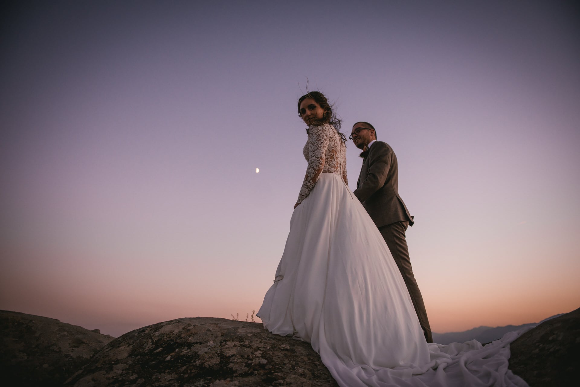 Couple posing on a rock on their Meteora wedding elopement
