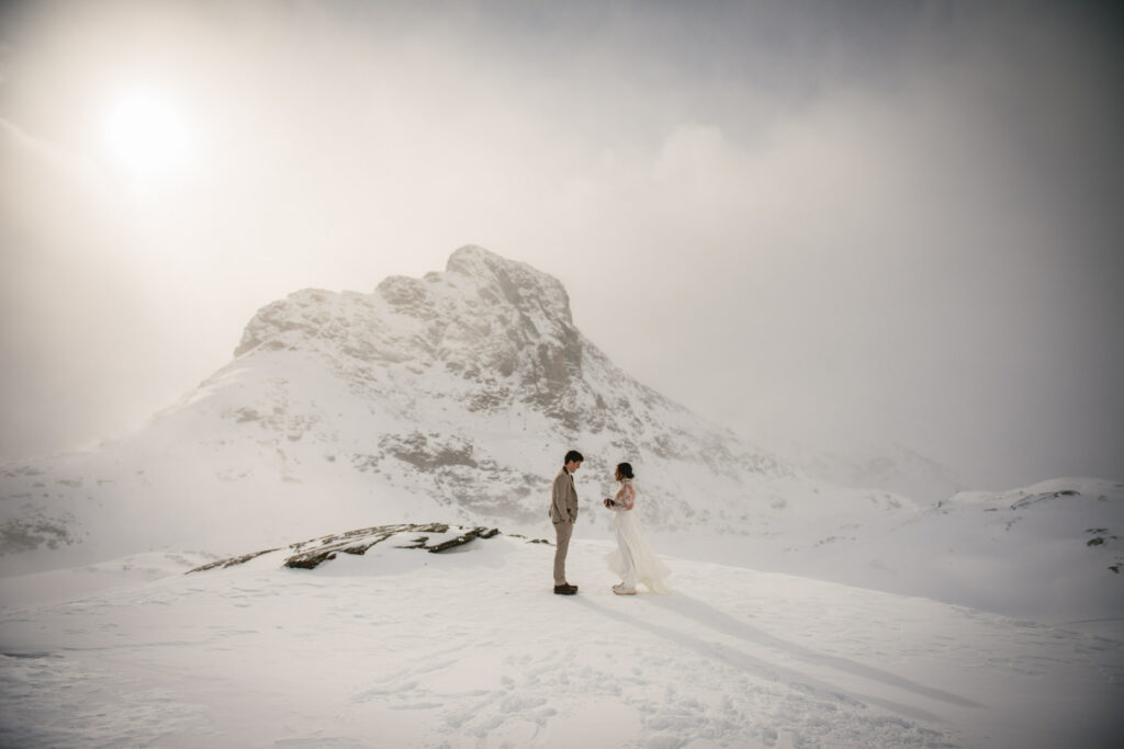 Couple exchanging their vows on their snowy elopement day in Zermatt
