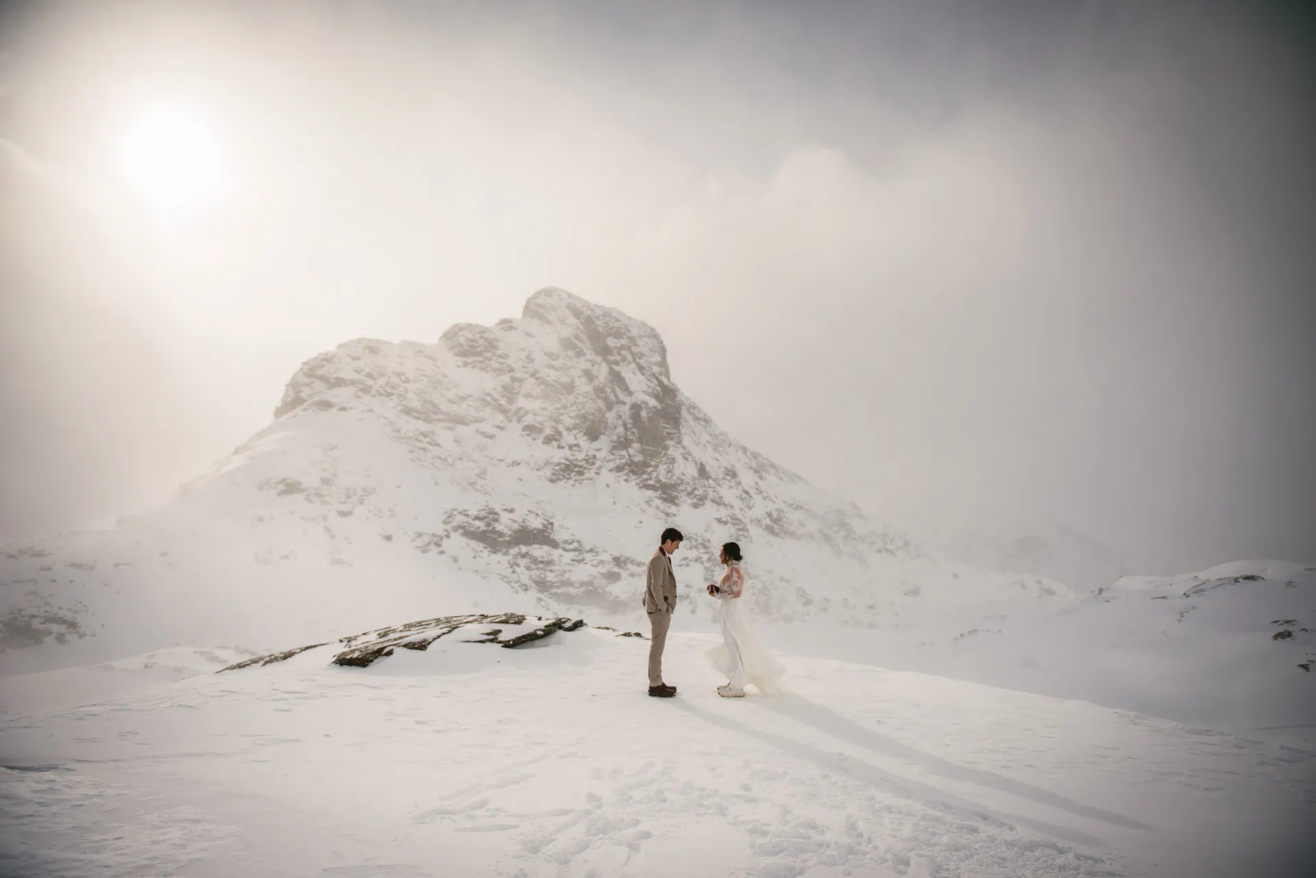 Couple exchanging their vows on their snowy elopement day in Zermatt