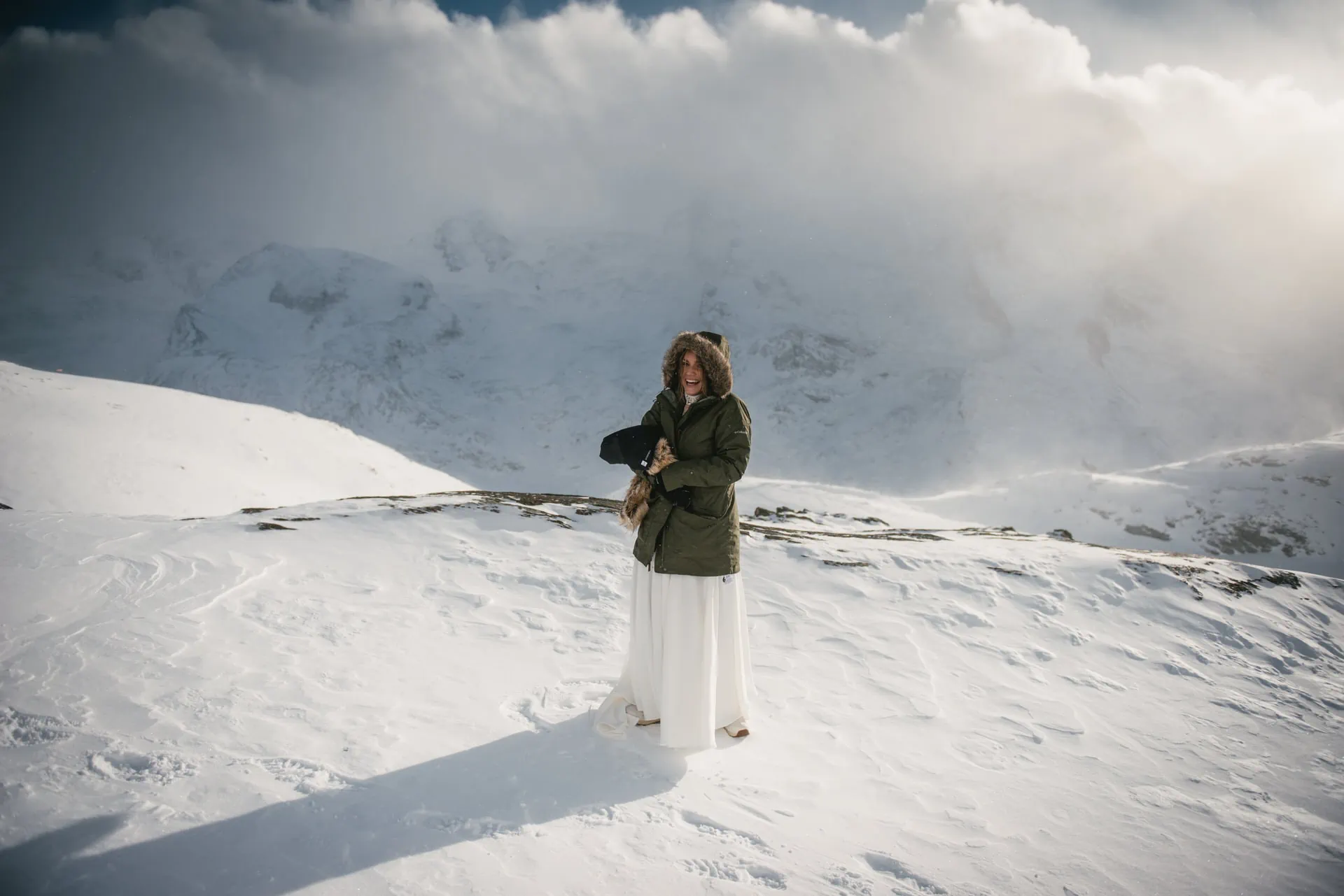 Couple exchanging their vows on their snowy elopement day in Zermatt