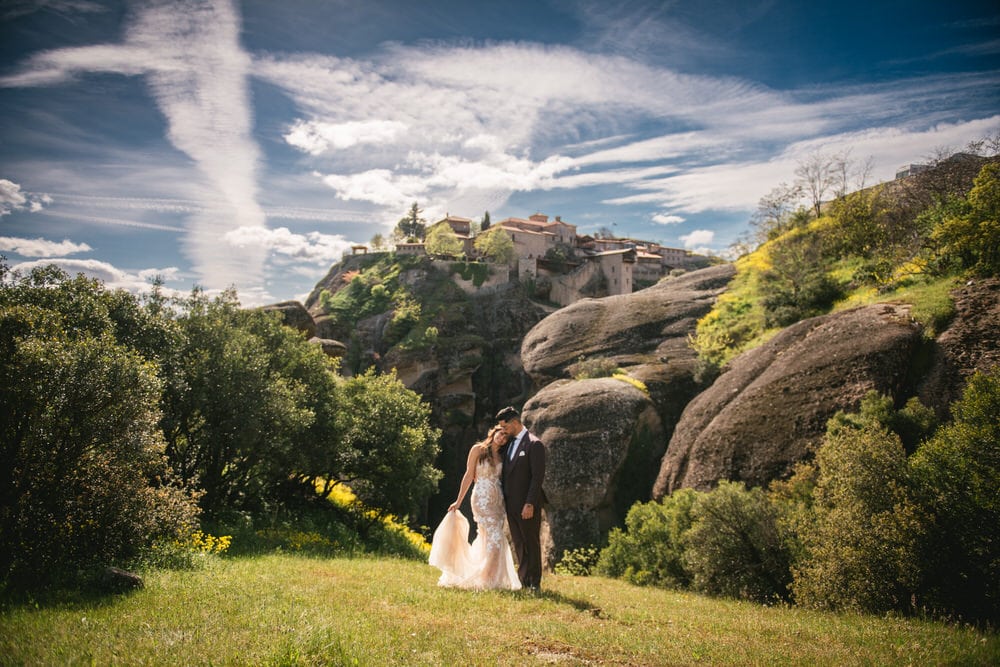 Couple hugging by a monastery on an elopement day in the Meteora in Greece