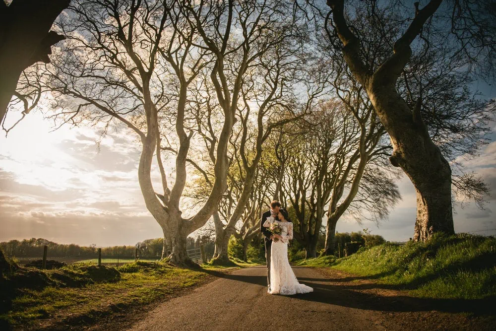 The couple's silhouettes against a breathtaking sunset backdrop during their Northern Ireland elopement.