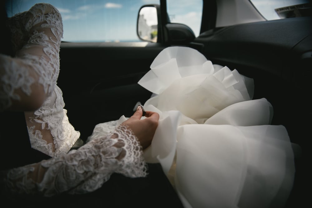 The bride's elegant lace veil gently billowing in the breeze during her Northern Ireland elopement.