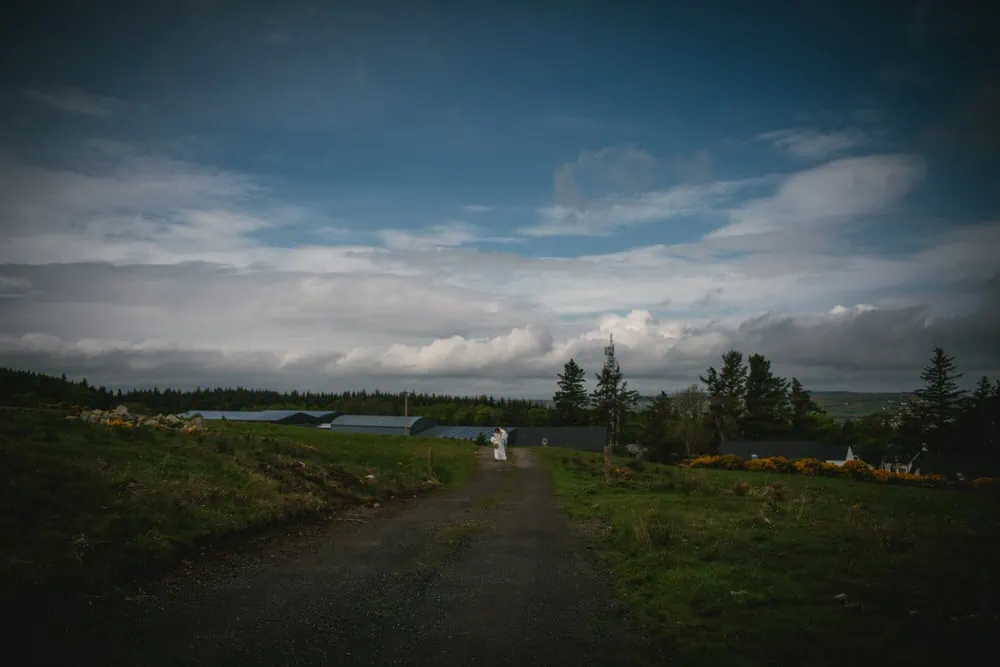 The bride walking up the hill for her first look on her elopement day in Northern Ireland
