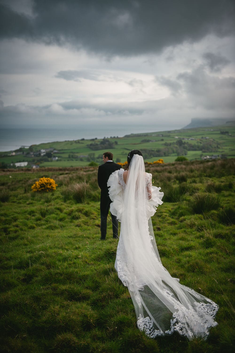 A loving couple embracing during their Northern Ireland elopement on the coastline.