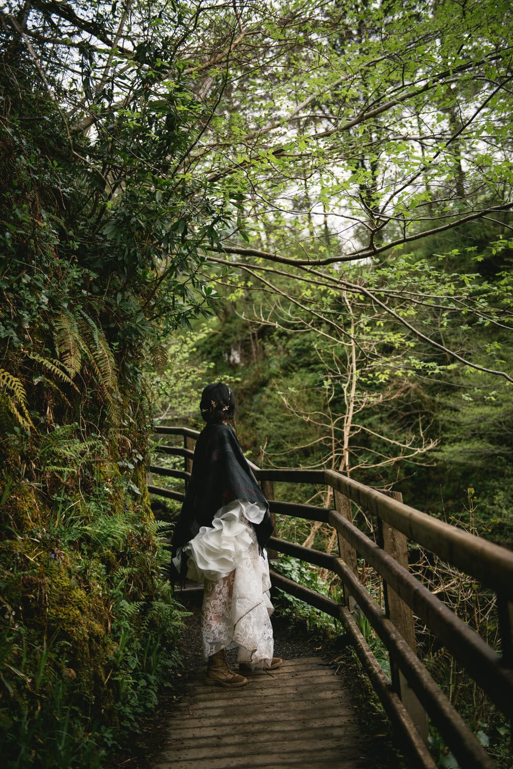 The couple laughing together as they explore the enchanting forest during their Northern Ireland elopement.