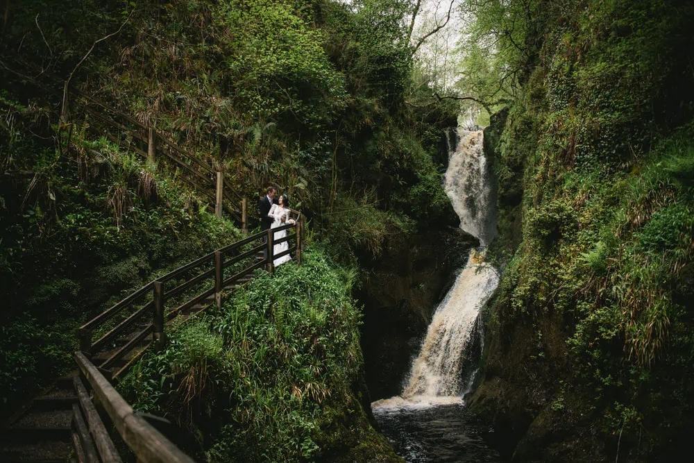 Hidden waterfall in the magical forest of their Northern Ireland elopement.