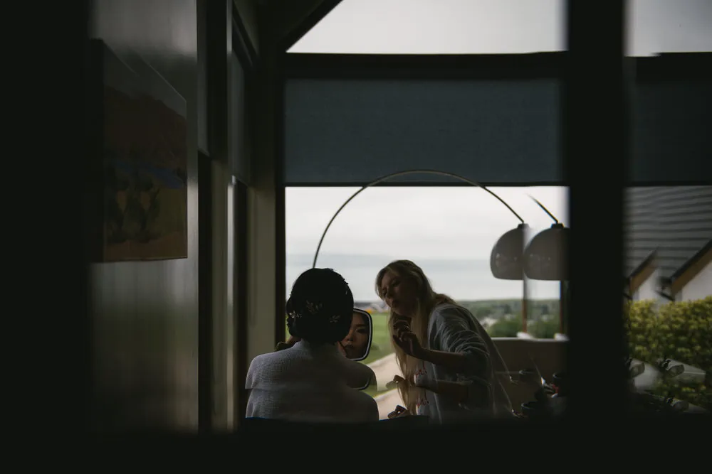 The bride's intricate updo hairstyle, adorned with delicate flowers during their Northern Ireland elopement.