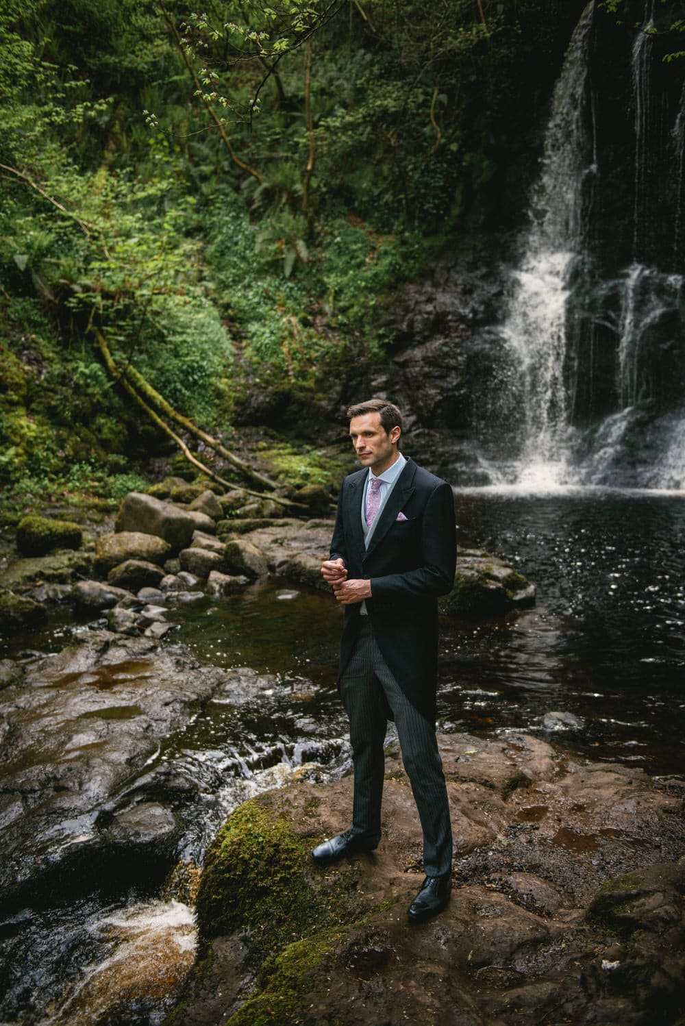 Hidden waterfall in the magical forest of their Northern Ireland elopement.