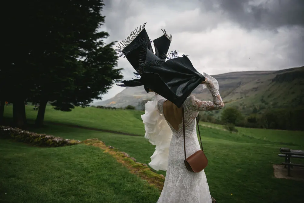 Candid shot of the bride putting a shawl on her elopement day in Northern Ireland