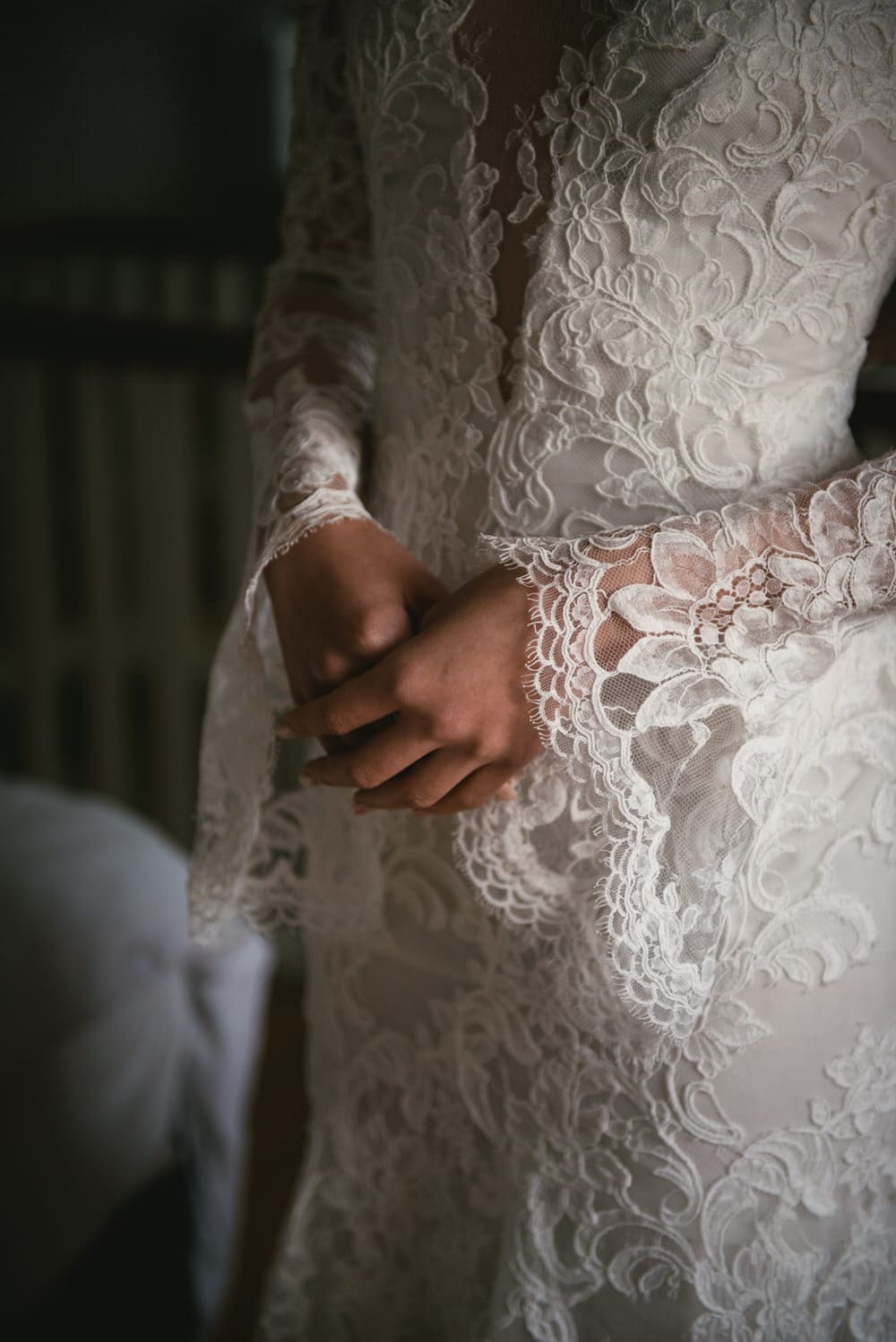 The bride's delicate lace sleeves and intricate back detail of her gown during their Northern Ireland elopement.