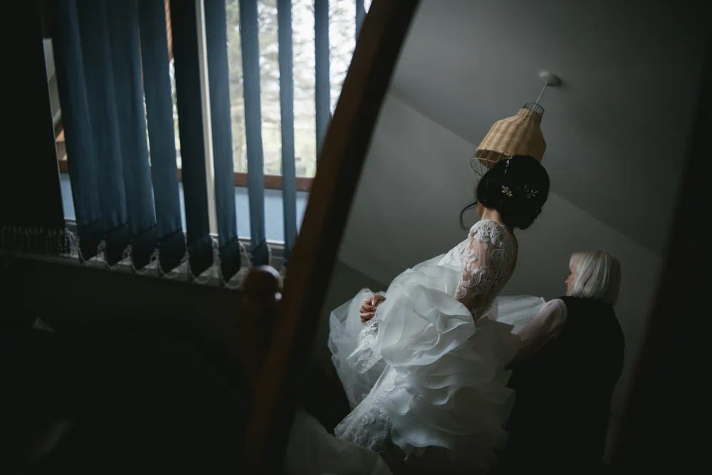 The bride's intricate braided hairstyle, adorned with flowers during their Northern Ireland elopement.