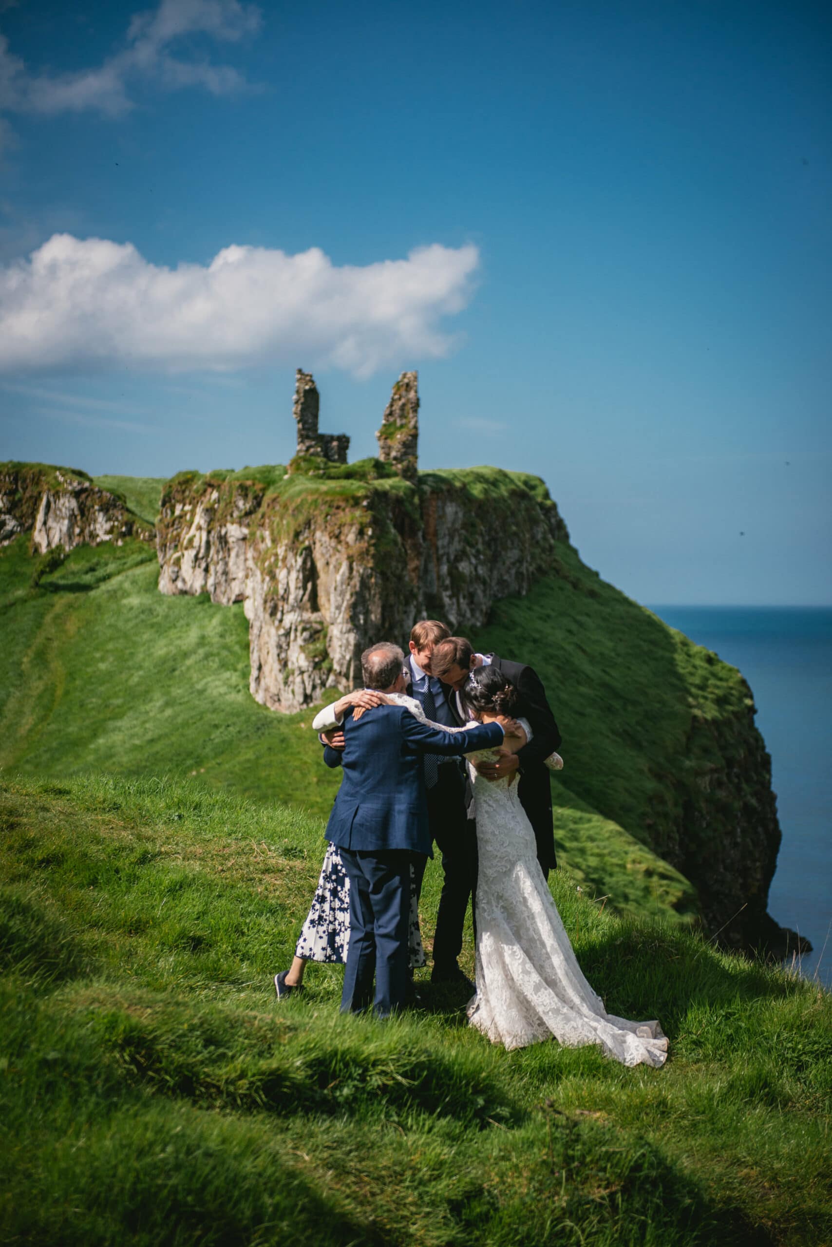 The couple's loving embrace, framed by the majestic architecture of the castle during their Northern Ireland elopement.
