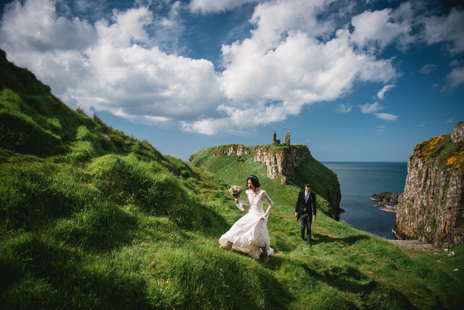 Candid shot of the couple sharing a private moment on a scenic hilltop during their Northern Ireland elopement.