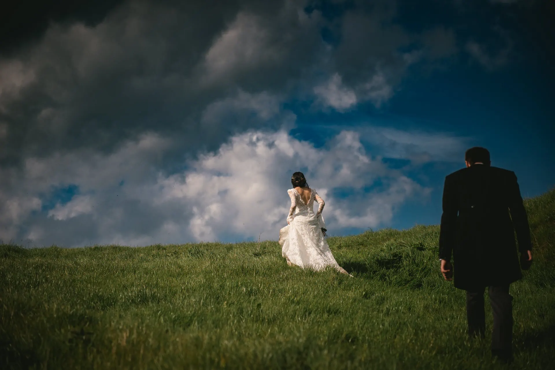 The couple walking hand in hand through a fairytale-like forest during their Northern Ireland elopement.