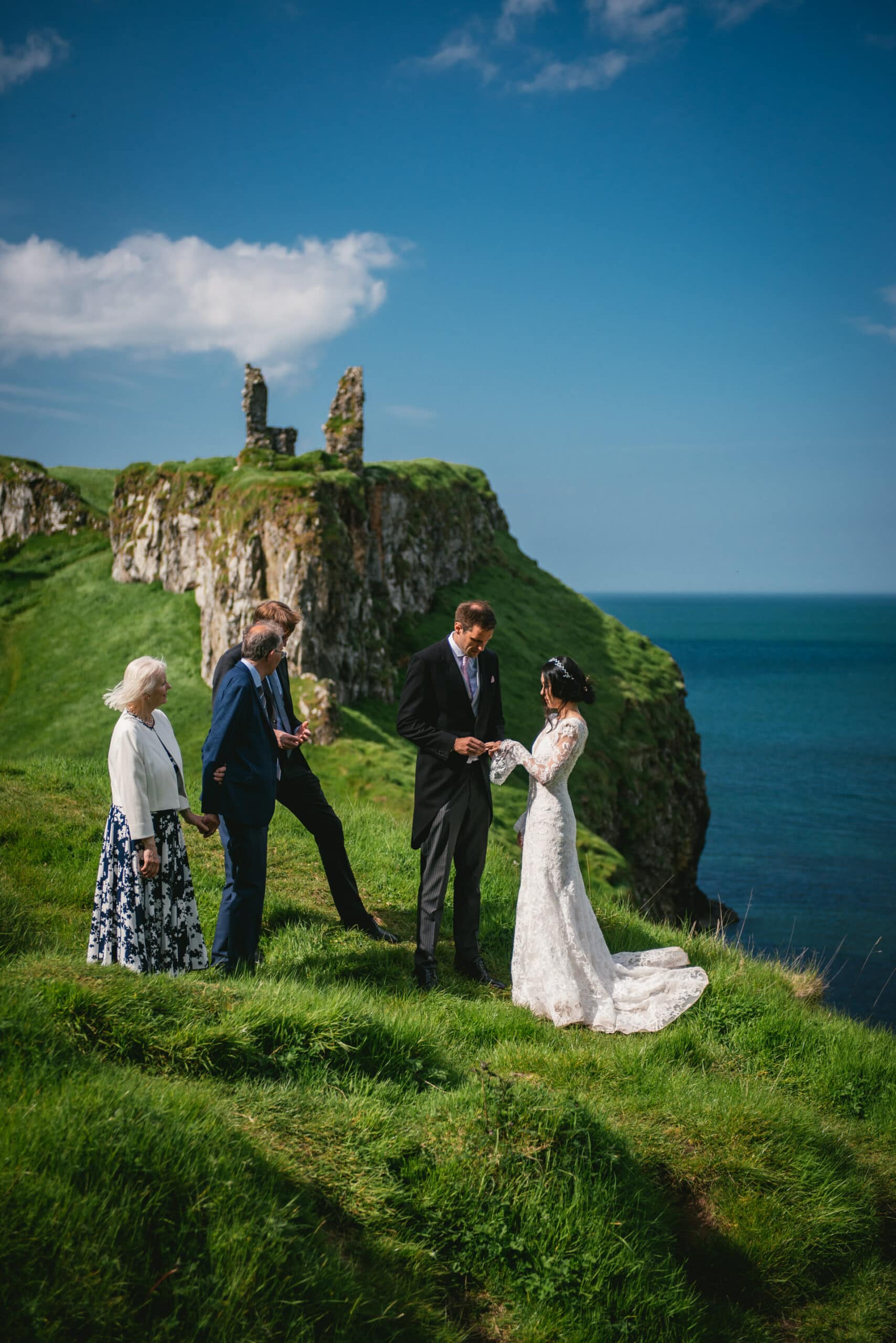 The couple exchanging heartfelt vows at historic castle ruins during their Northern Ireland elopement.