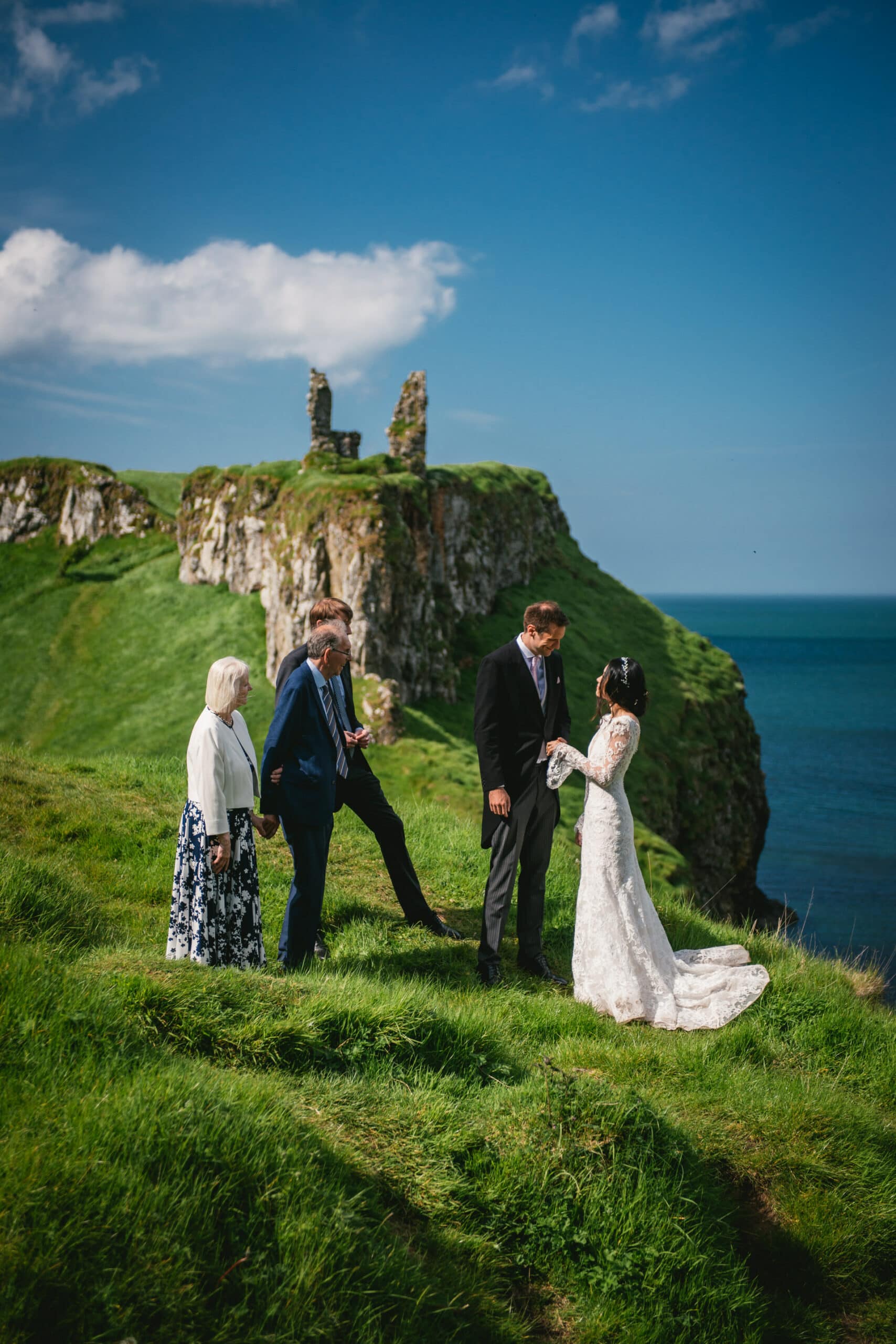 Panoramic view of ancient castle ruins against the Northern Ireland countryside during their elopement.