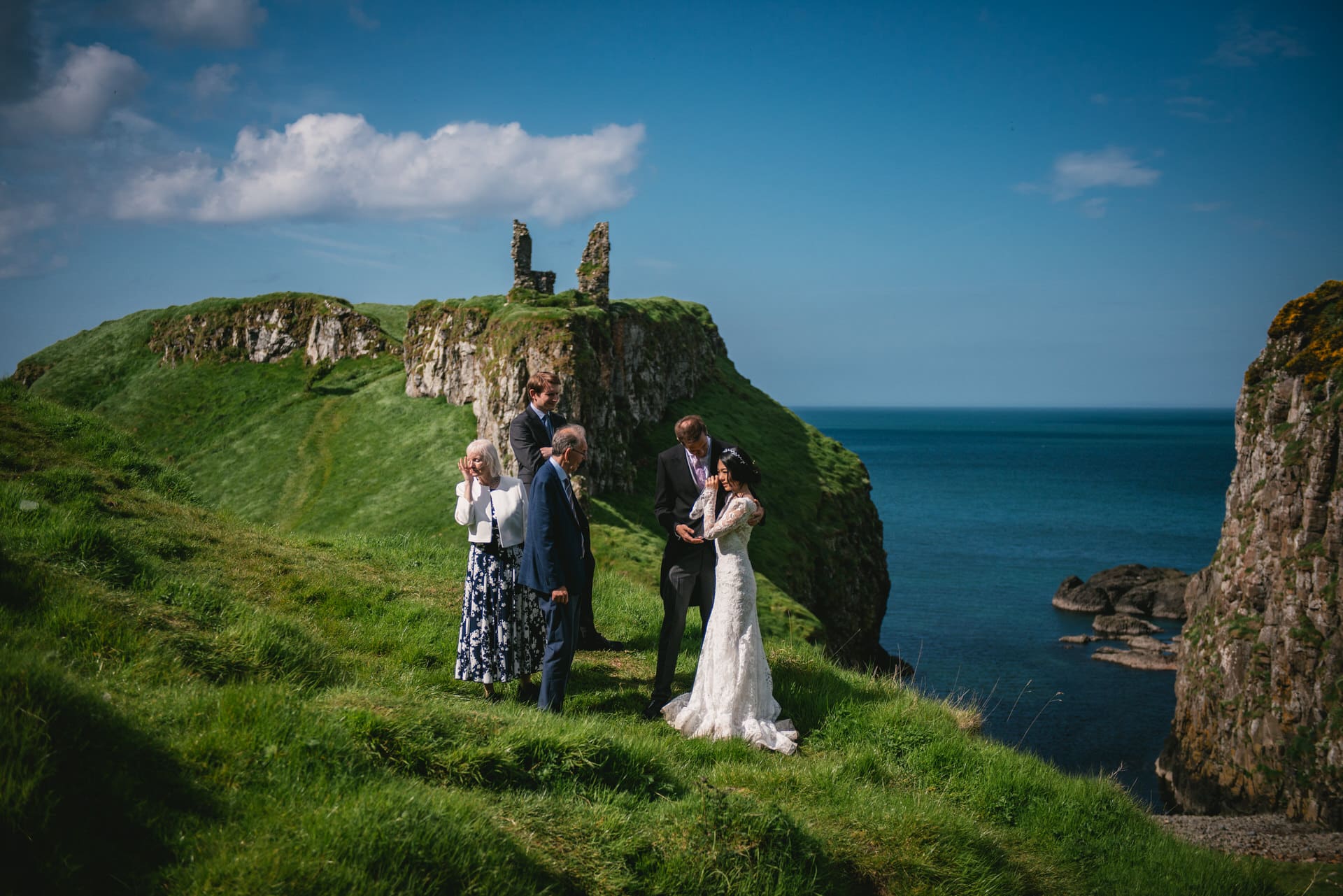 The couple sharing a heartfelt moment as they stand before the castle ruins during their Northern Ireland elopement.