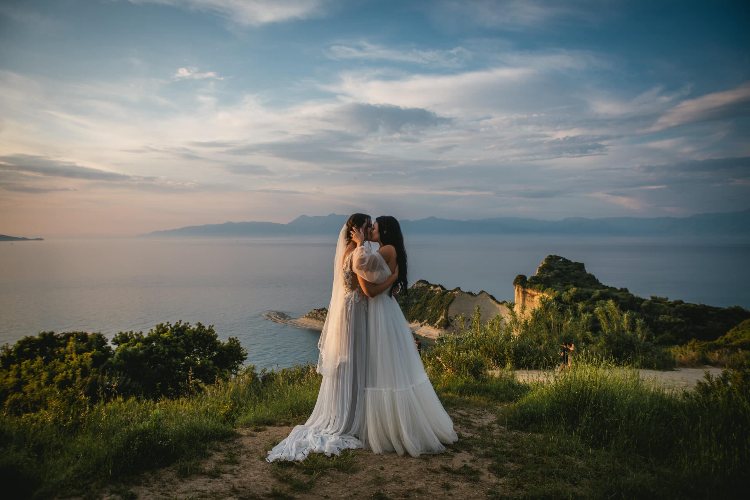 The couple holding hands, surrounded by love in their Corfu elopement.