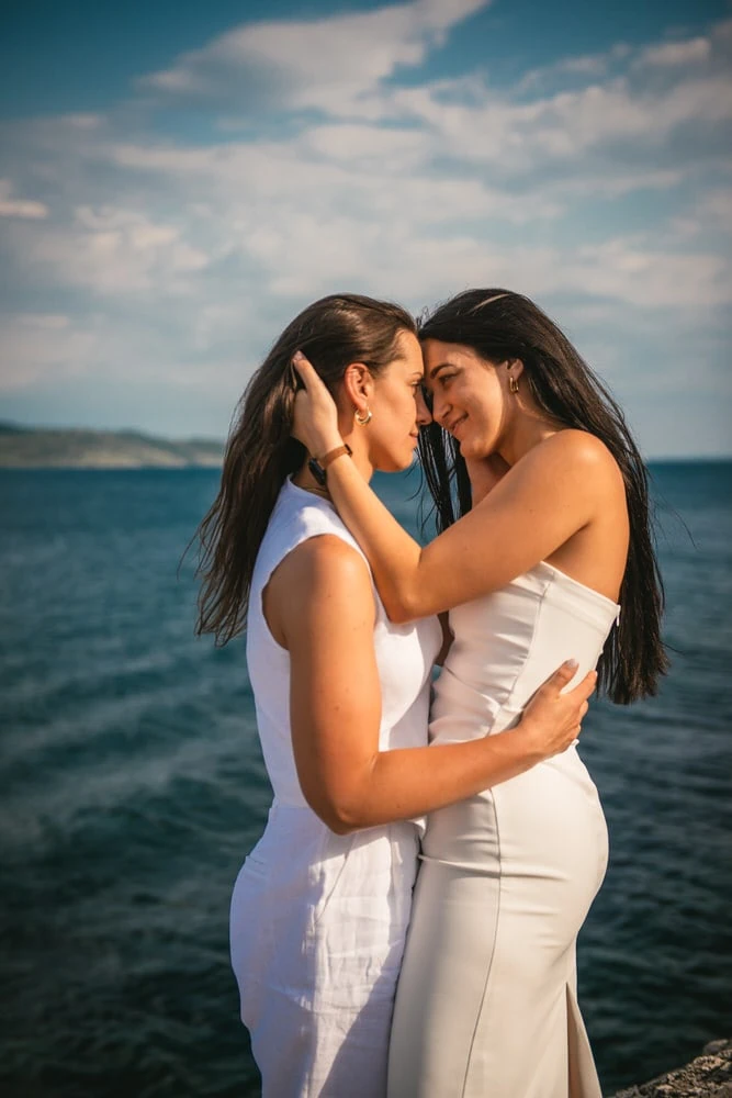 Seaside reverie: Brides walk along the shore, love's path traced in the sands during their Corfu elopement.