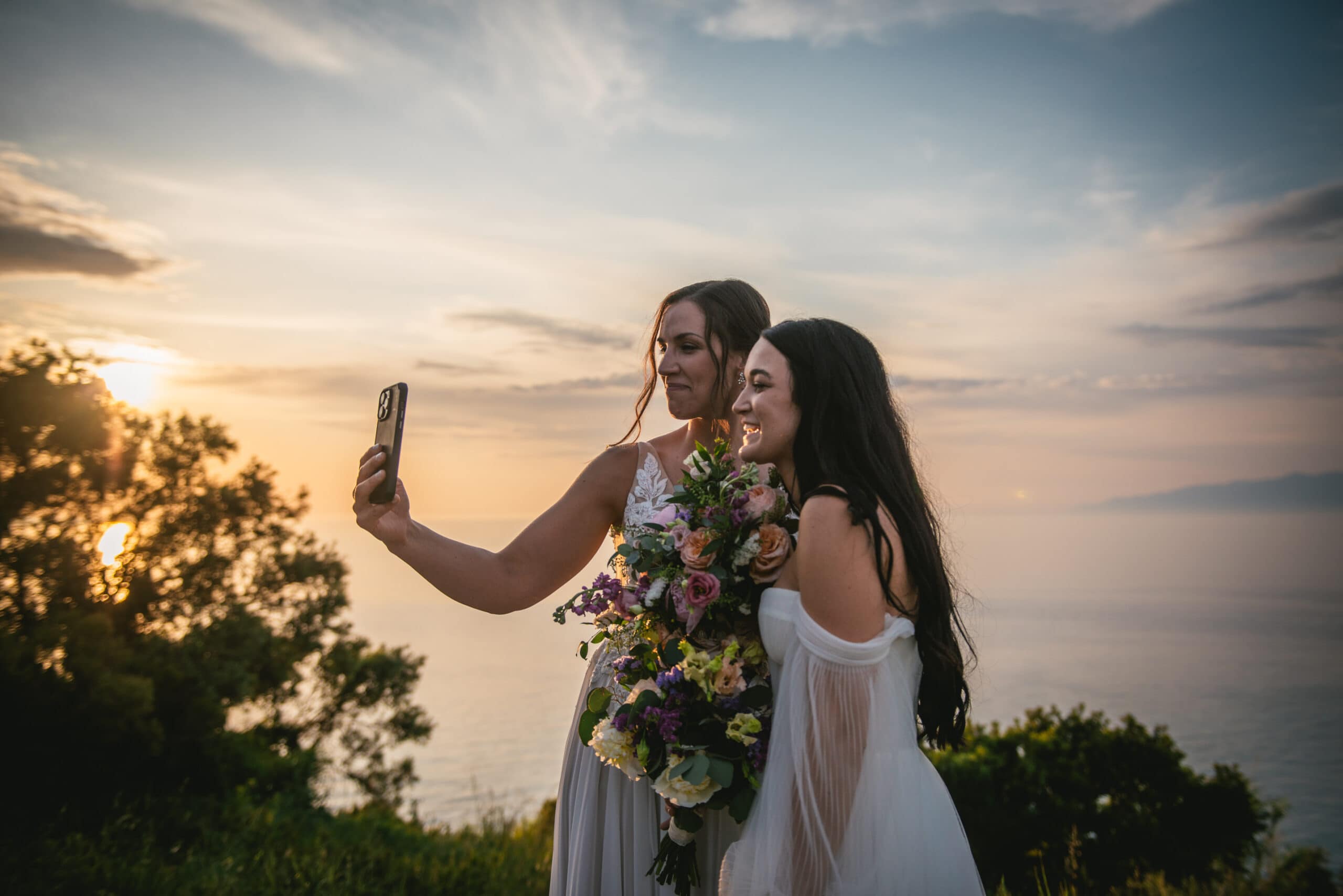 Brides sharing virtual moments with families, uniting hearts in their Corfu elopement.