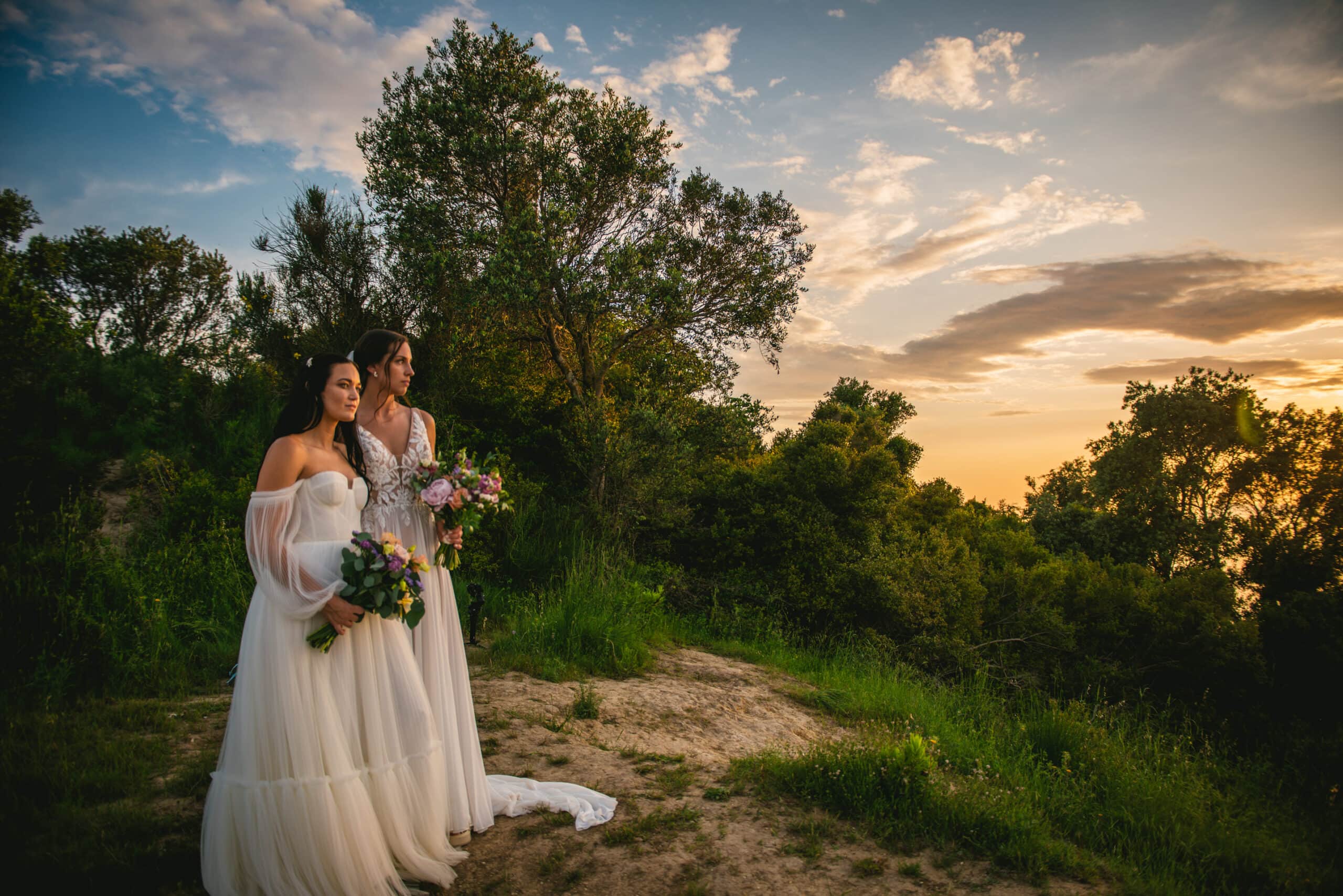 Brides gazing at the sea during sunset, dreamy moments of their Corfu elopement.
