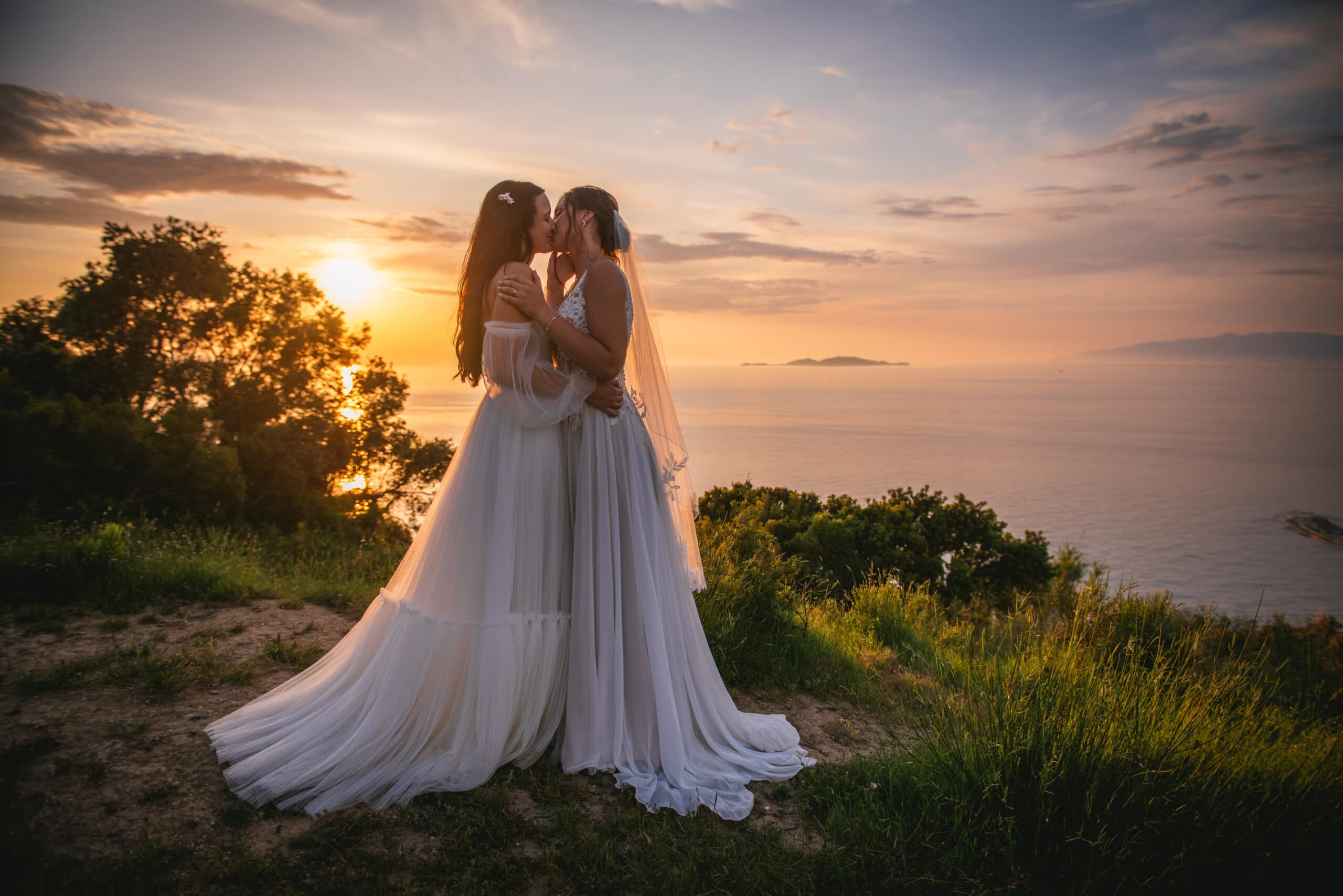 Brides bathed in sunset's glow, creating a magical moment in Corfu elopement.