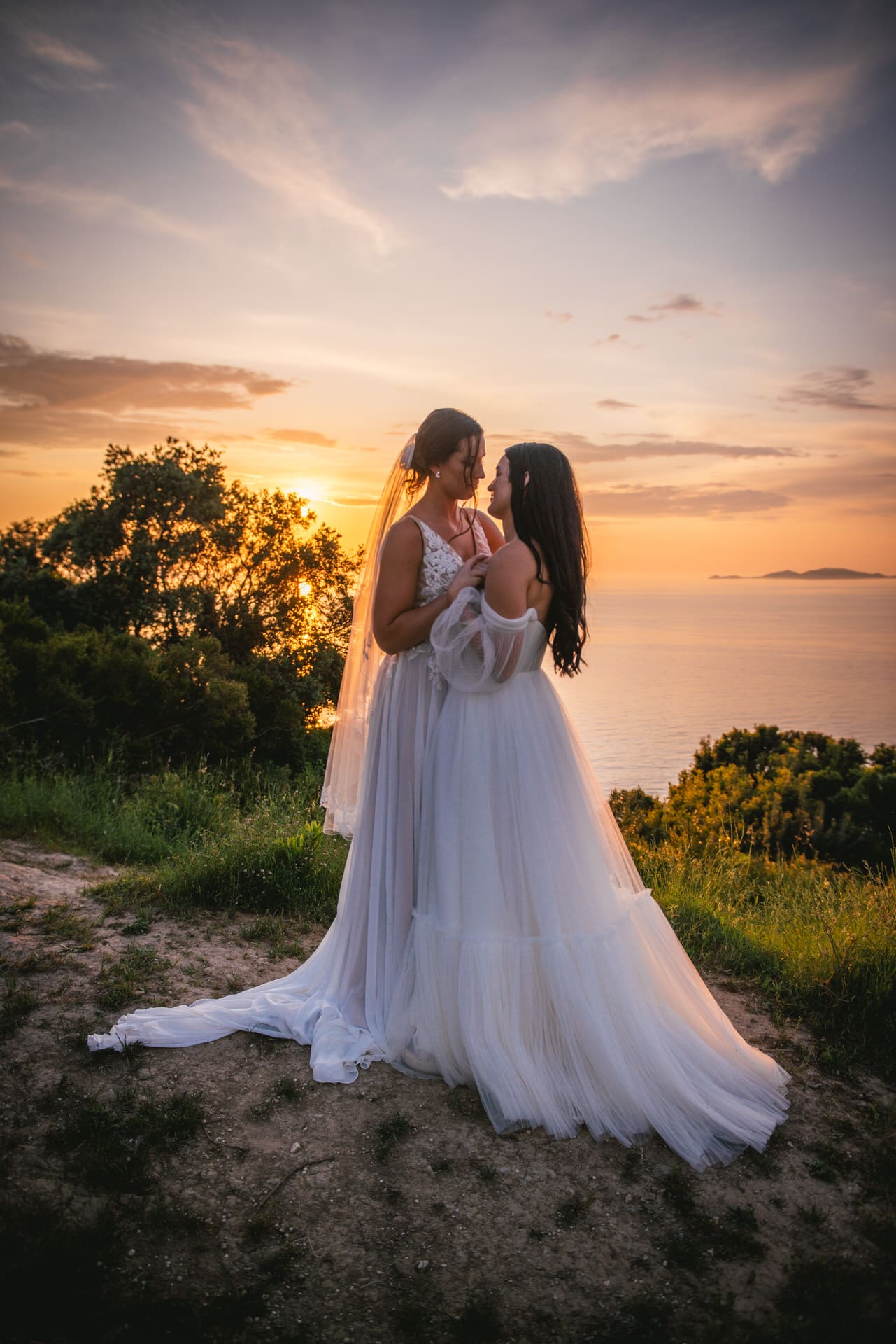 Brides dancing gracefully as the sun sets, a love-filled dance in Corfu elopement.