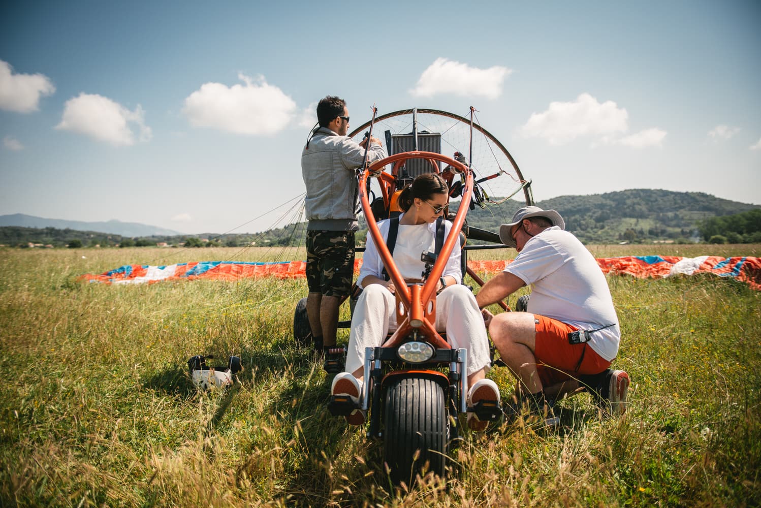 Bride's exhilaration before paragliding, a daring adventure during their Corfu elopement.