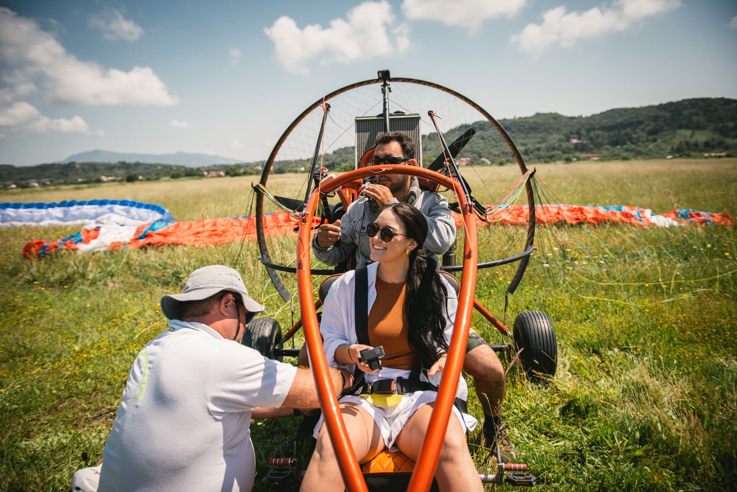 The other bride ready for her paragliding experience, capturing thrilling moments in Corfu.